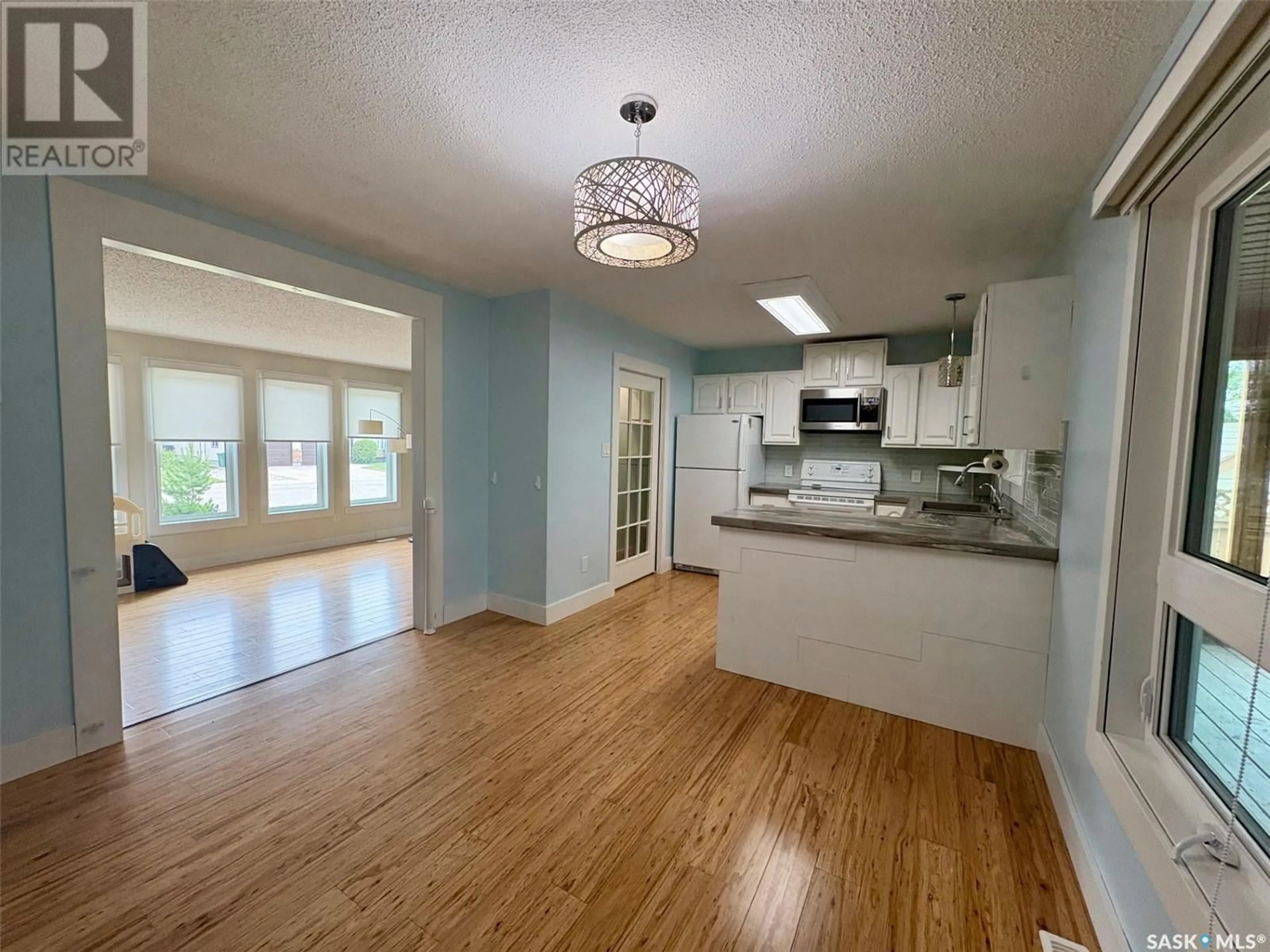 Open concept kitchen, wood/laminate floor for 40 BULL CRESCENT, Yorkton Saskatchewan S3N3W7