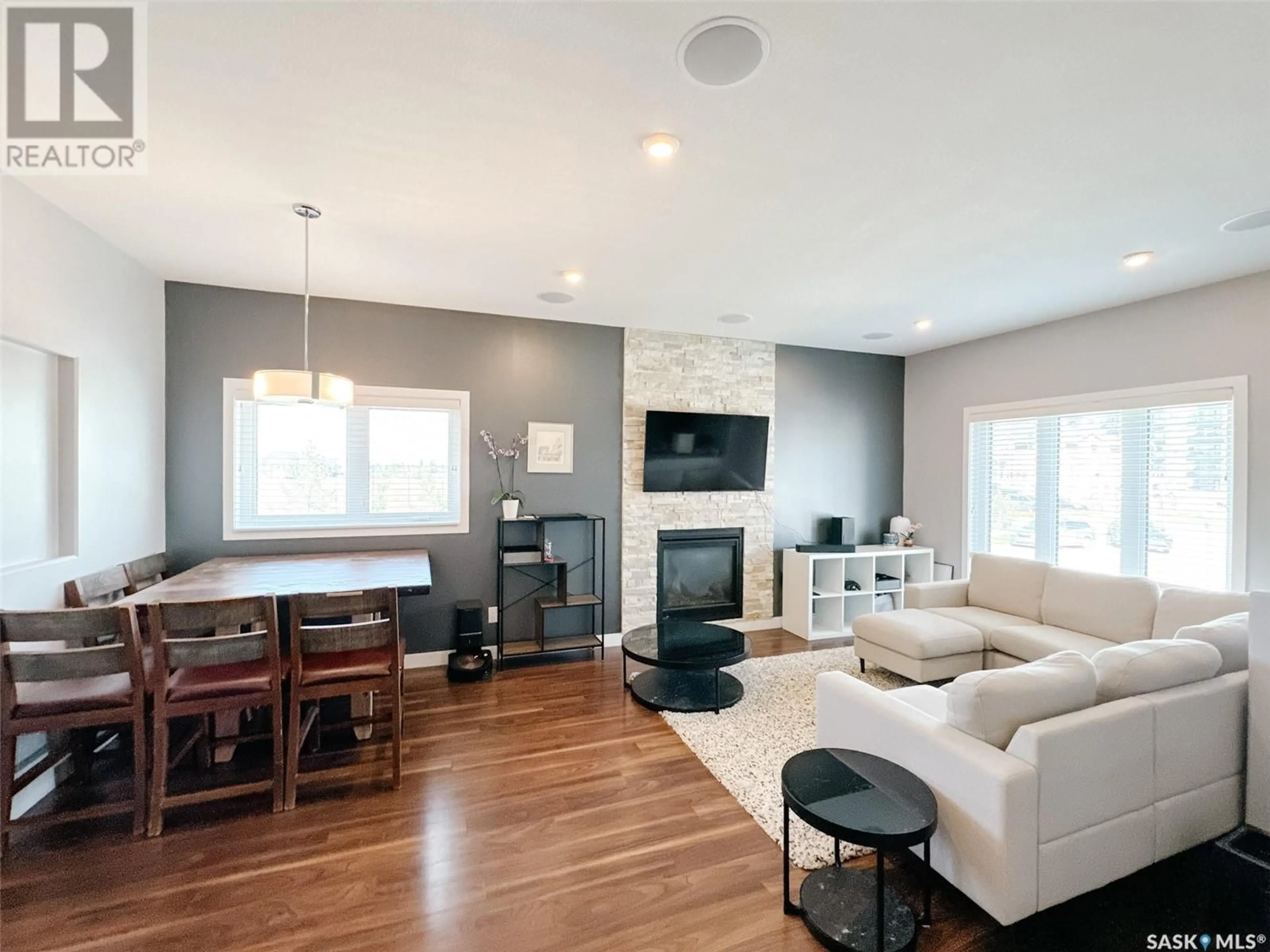 Living room with furniture, wood/laminate floor for 575 MARLATTE LANE, Saskatoon Saskatchewan S7W0S8