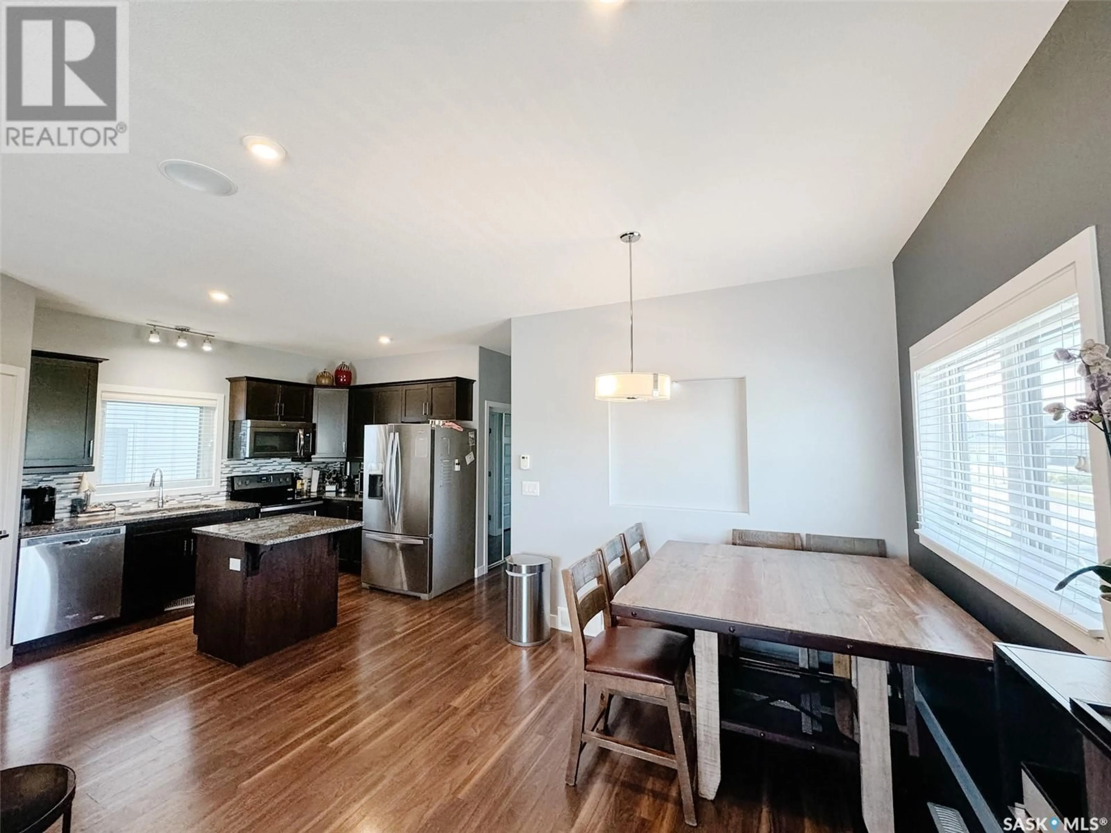 Open concept kitchen, wood/laminate floor for 575 MARLATTE LANE, Saskatoon Saskatchewan S7W0S8