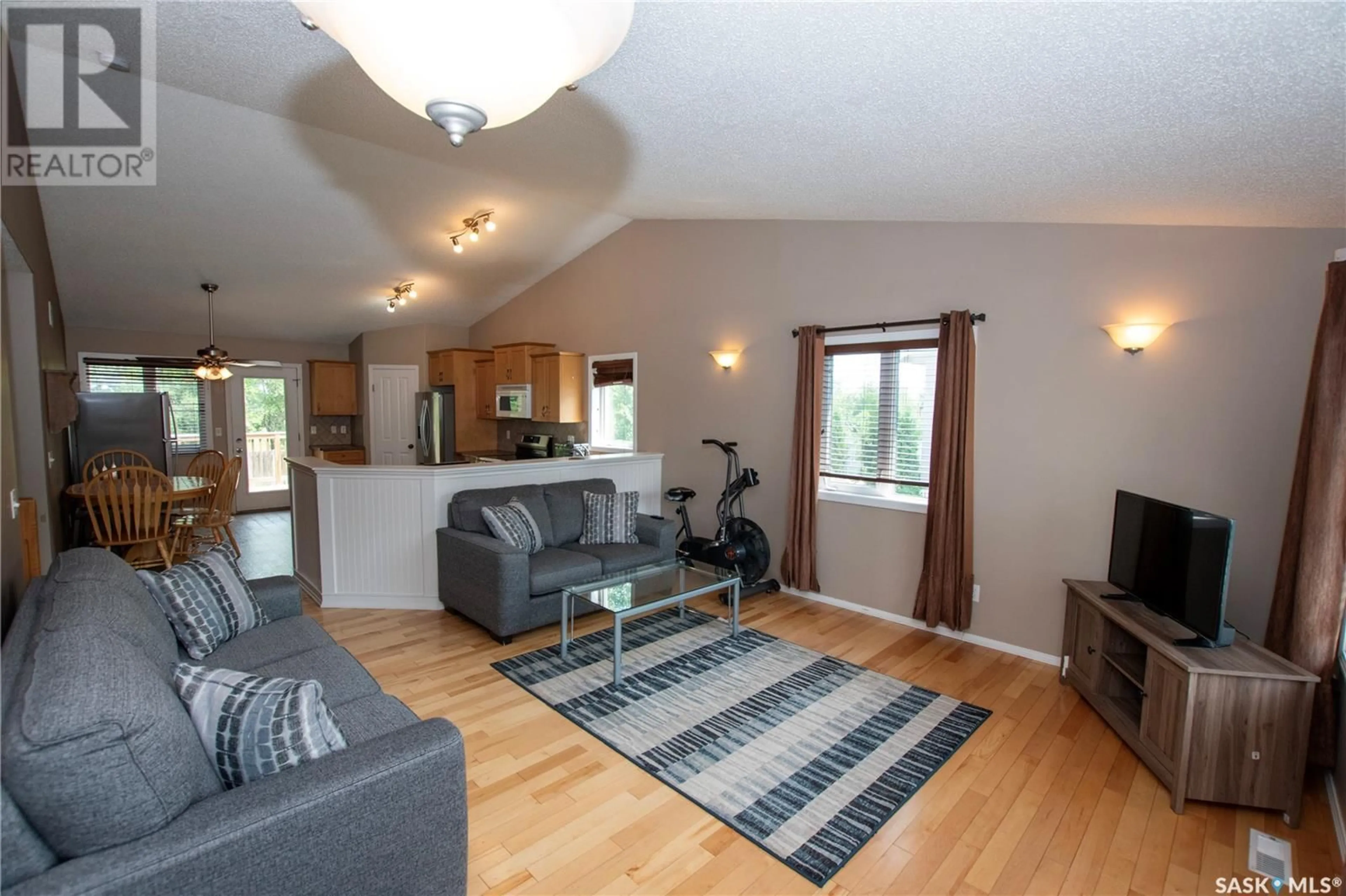 Living room with furniture, wood/laminate floor for 340 CLARK AVENUE, Asquith Saskatchewan S0K0J0