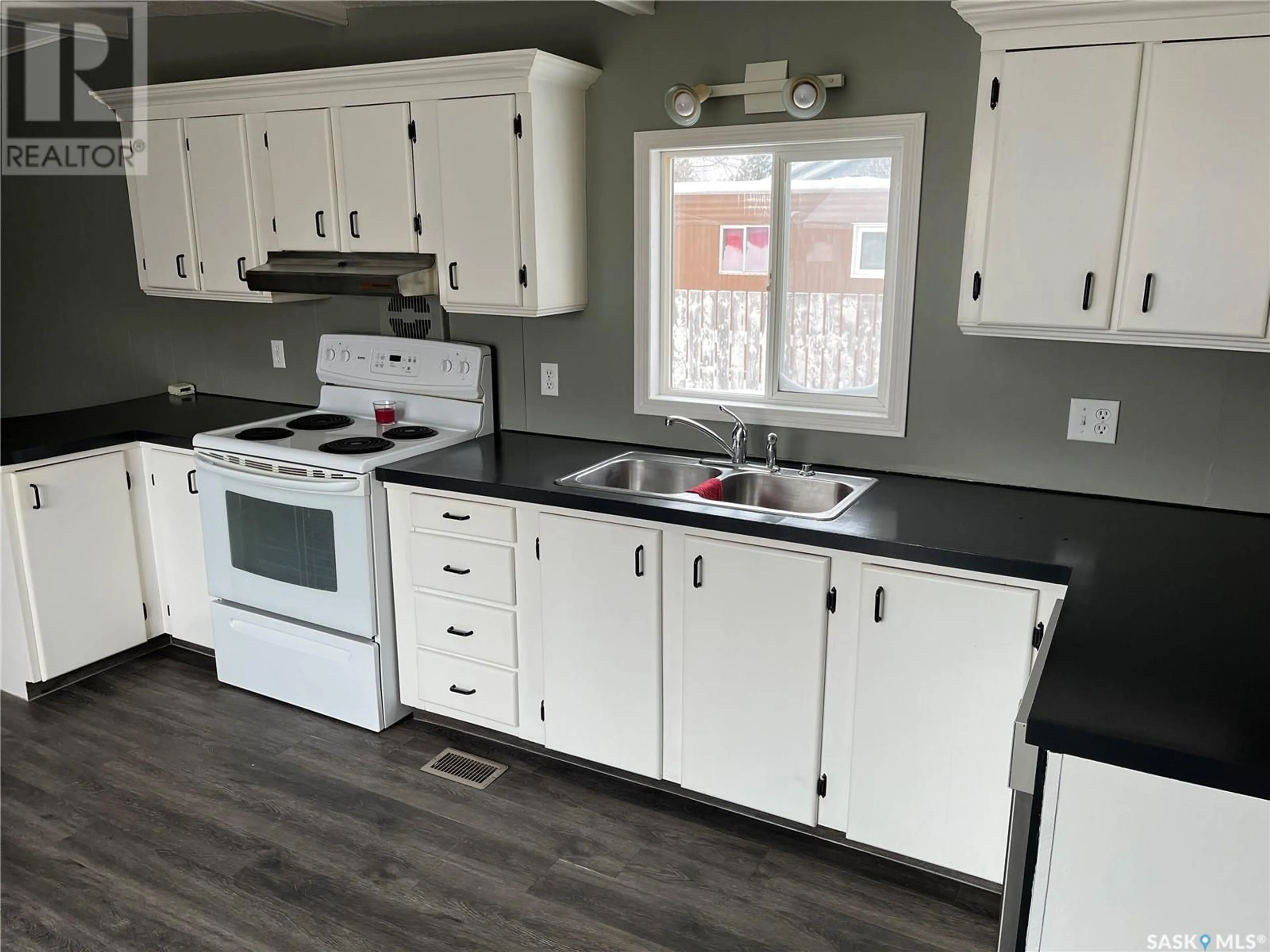 Open concept kitchen, wood/laminate floor for 185 LAING CRESCENT, Weyburn Saskatchewan S4H2R8
