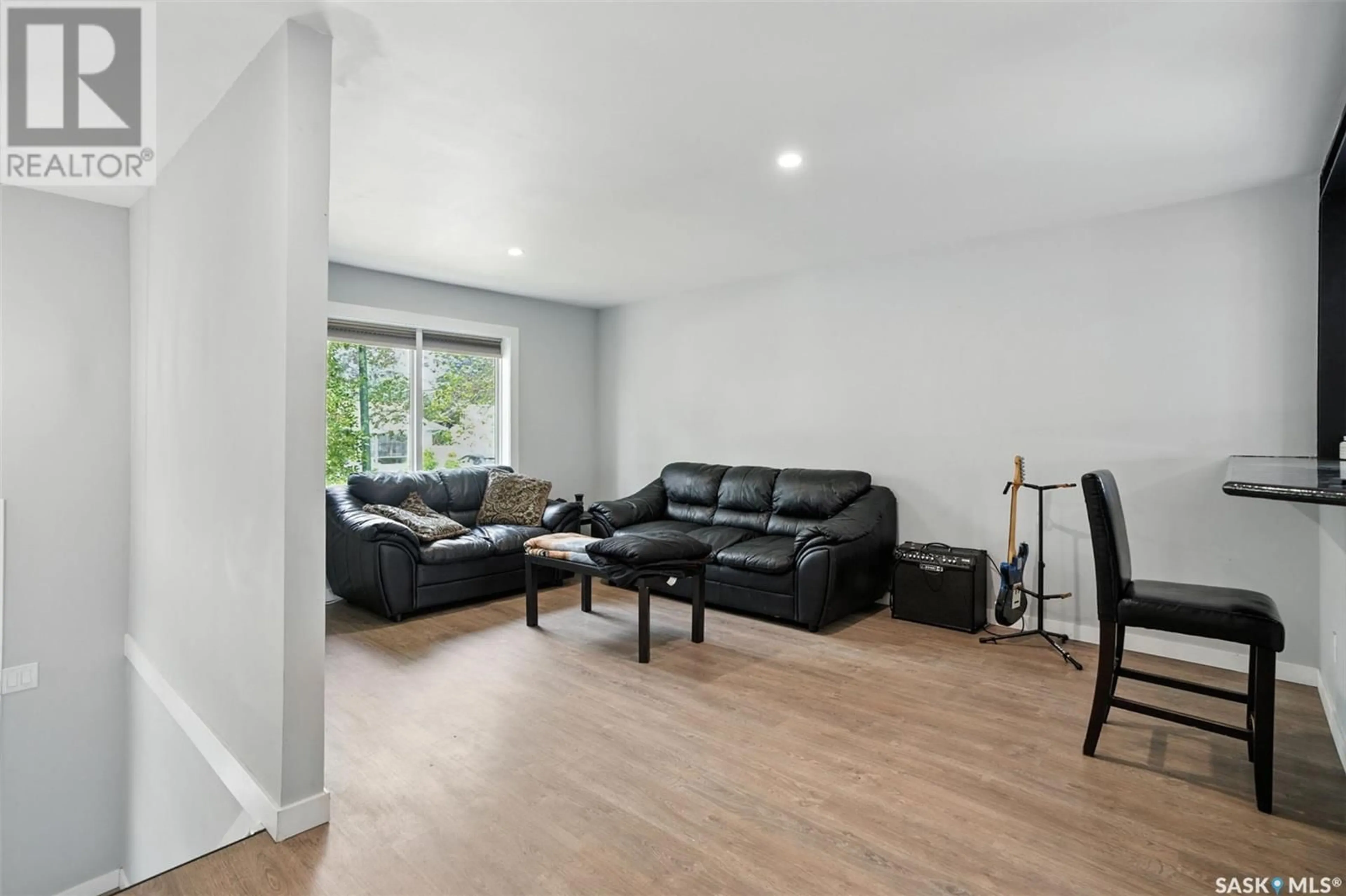 Living room with furniture, wood/laminate floor for 347 SEBESTYEN CRESCENT, Saskatoon Saskatchewan S7K6W2
