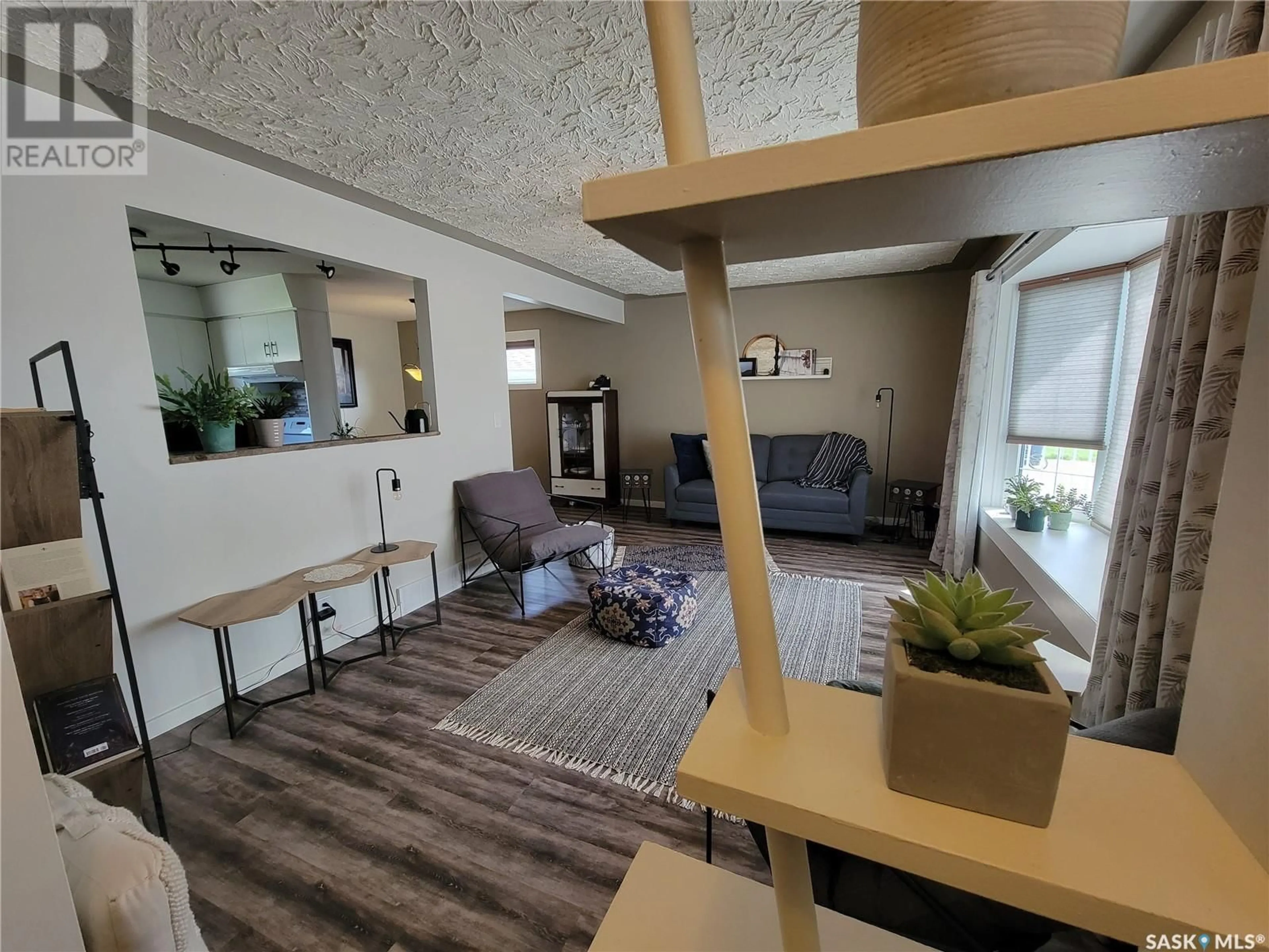 Living room with furniture, wood/laminate floor for 5103 LEADER STREET, Macklin Saskatchewan S0L2C0