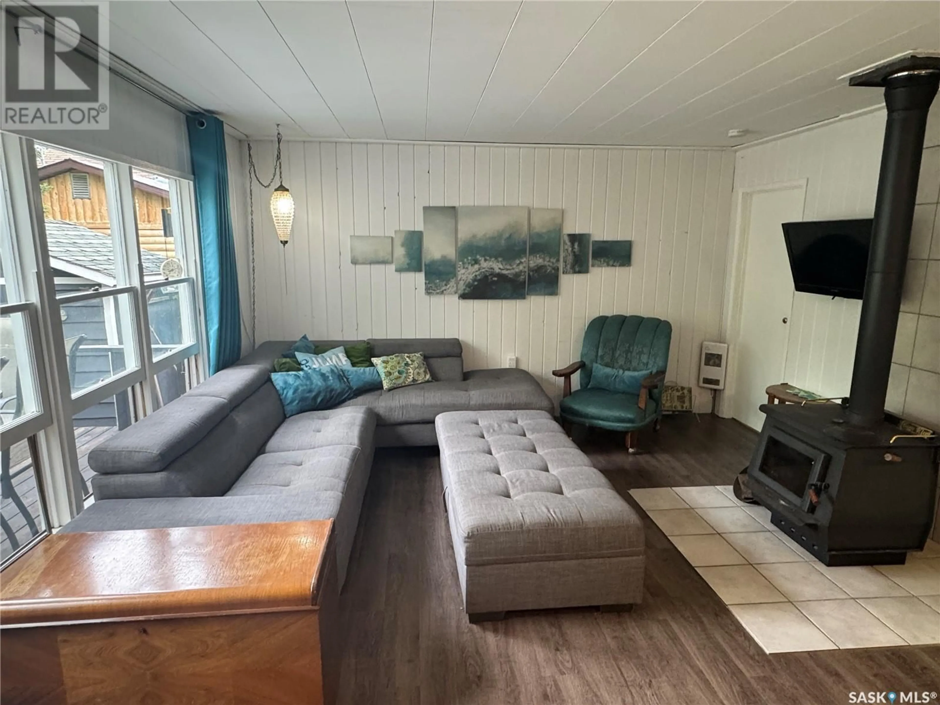 Living room with furniture, wood/laminate floor for 1504 SPRUCE STREET, Northern Admin District Saskatchewan S0J1L0