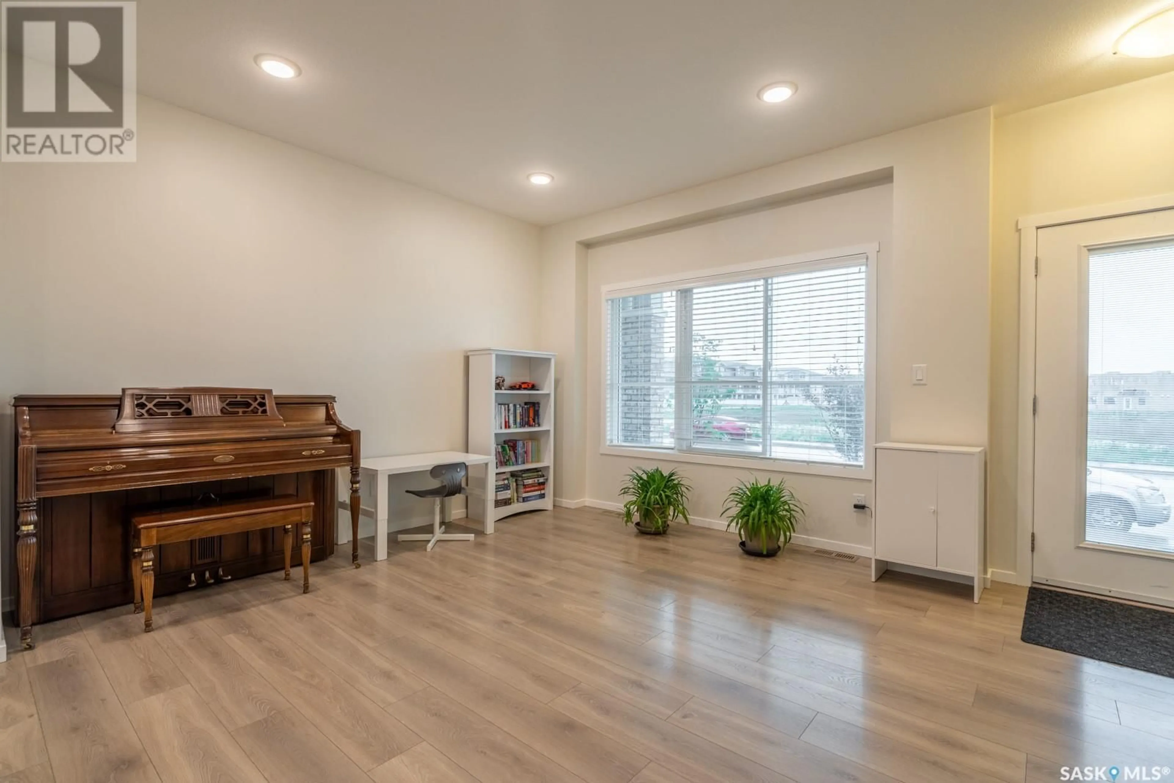 Living room with furniture, wood/laminate floor for 5008 PRIMROSE GREEN DRIVE, Regina Saskatchewan S4V3S5