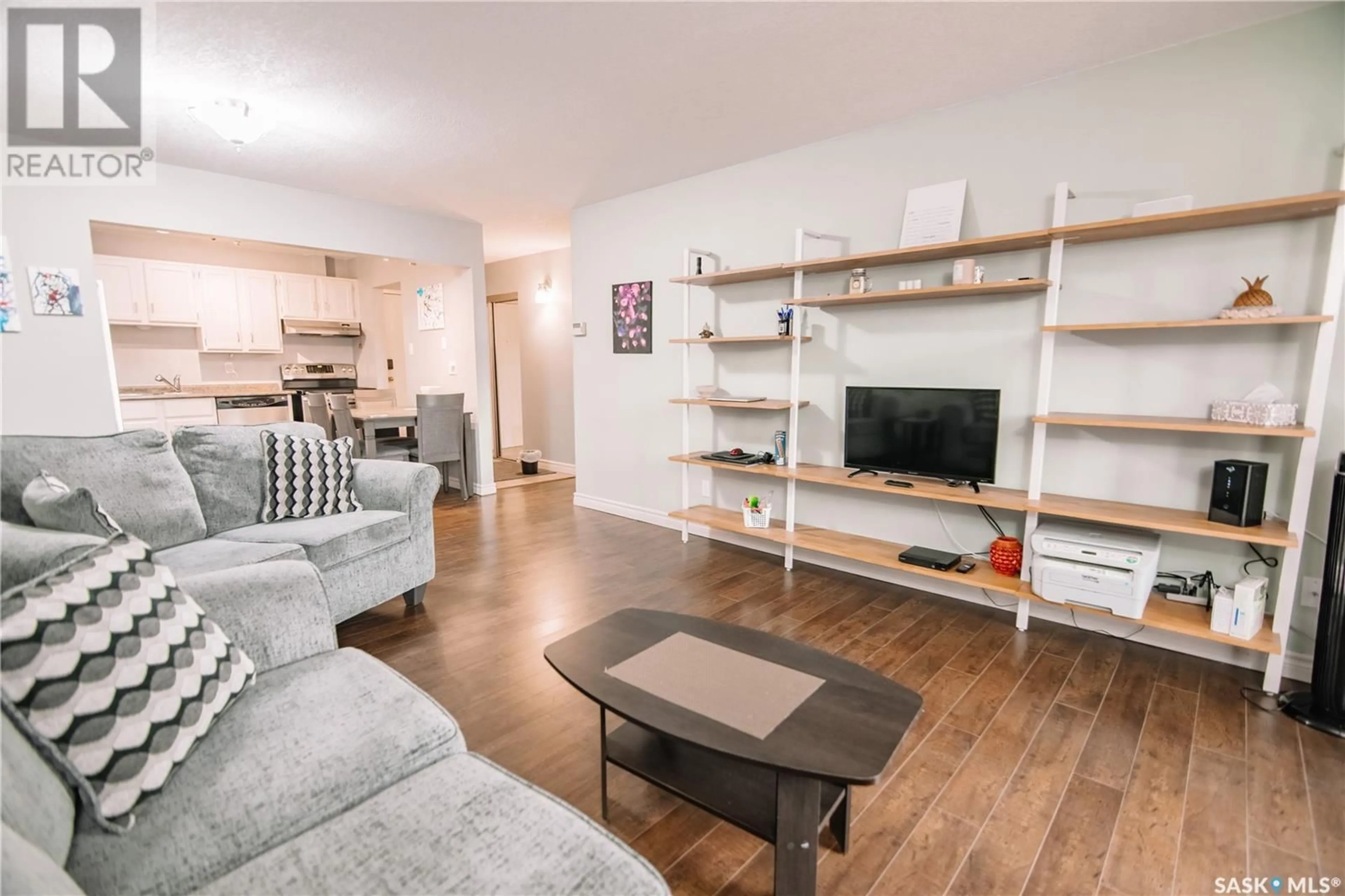 Living room with furniture, wood/laminate floor for 304 - 2237 MCINTYRE STREET, Regina Saskatchewan S4P2S1