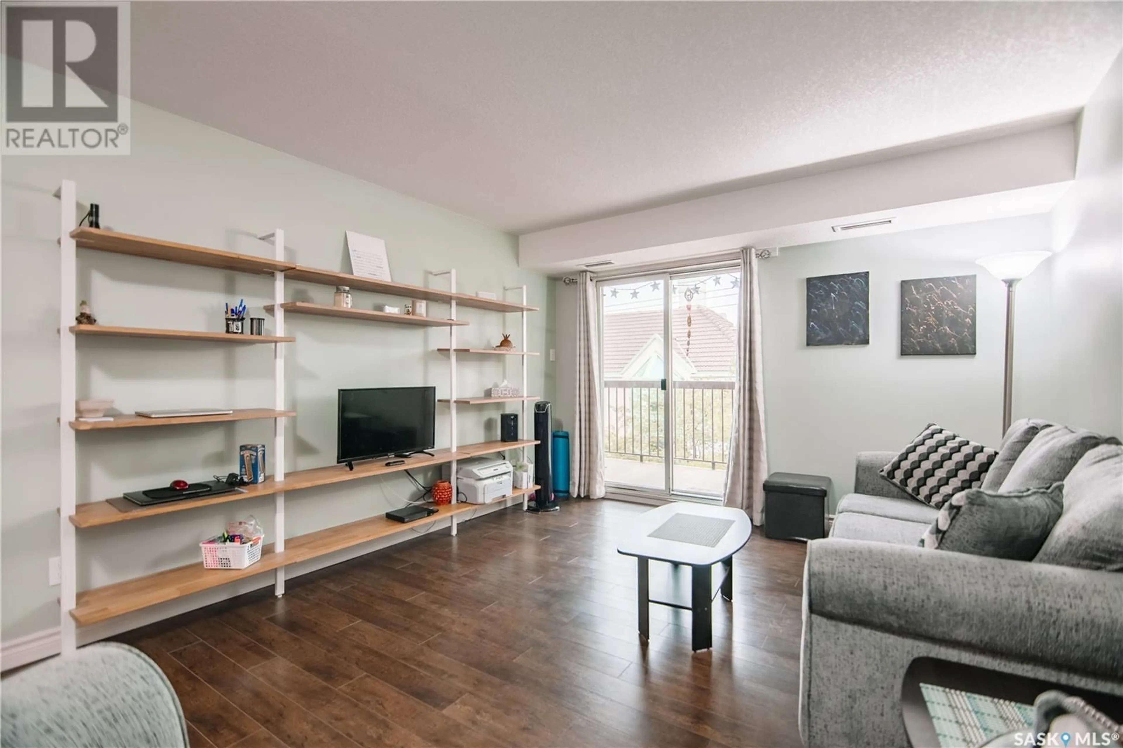 Living room with furniture, wood/laminate floor for 304 - 2237 MCINTYRE STREET, Regina Saskatchewan S4P2S1