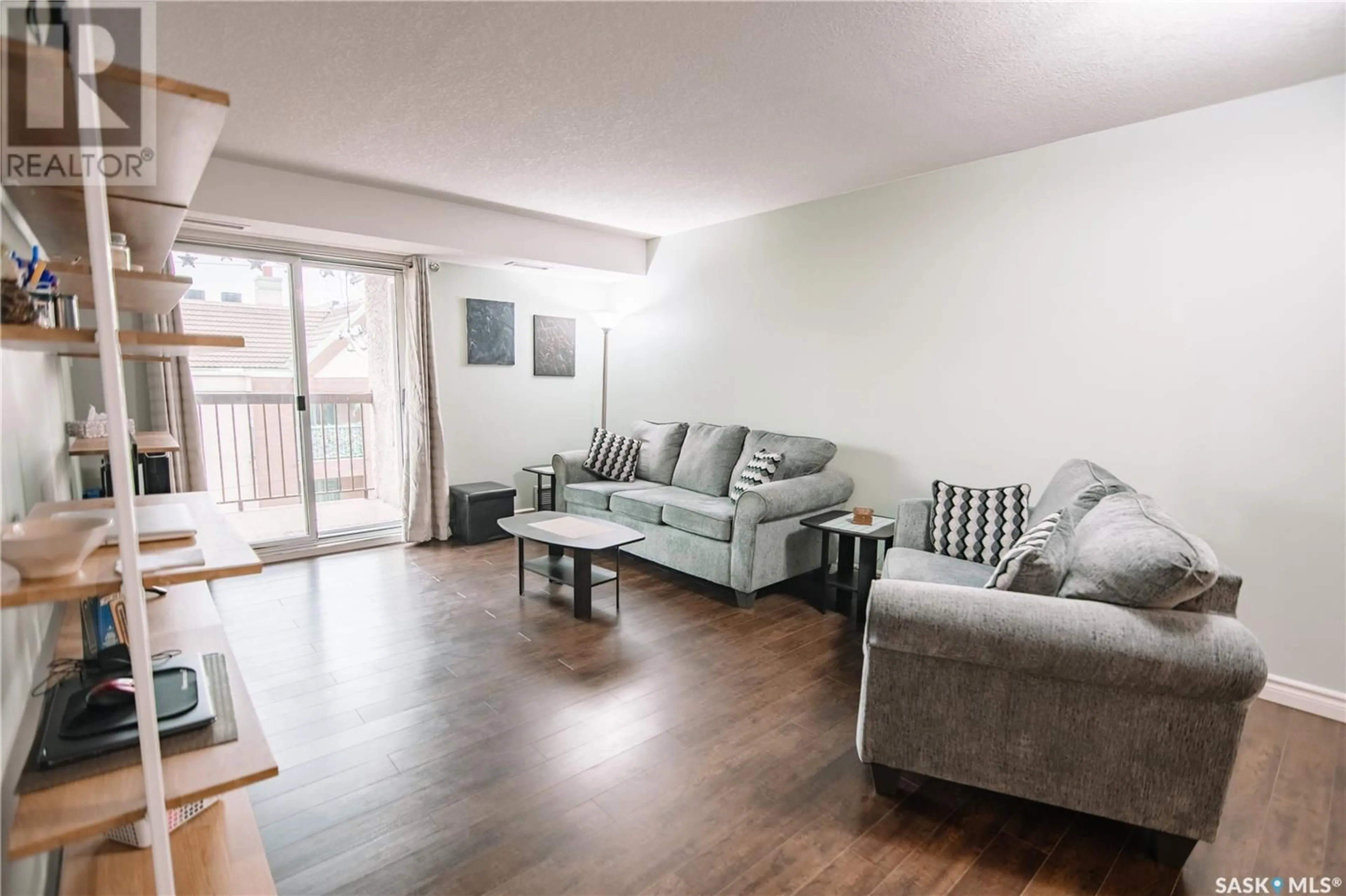 Living room with furniture, wood/laminate floor for 304 - 2237 MCINTYRE STREET, Regina Saskatchewan S4P2S1