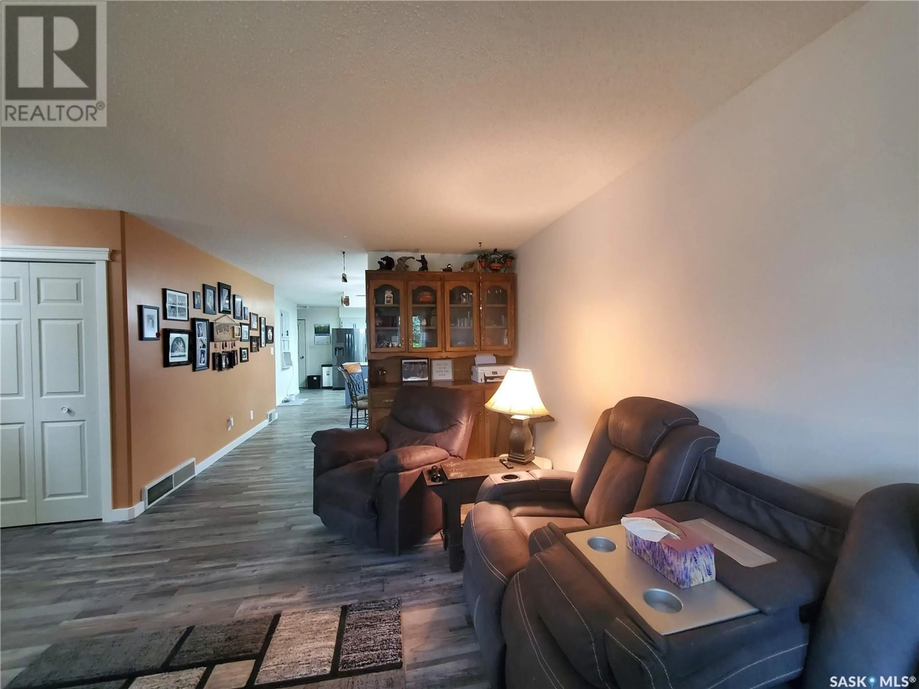 Living room with furniture, wood/laminate floor for 312 STEWART STREET, Kamsack Saskatchewan S0A1S0