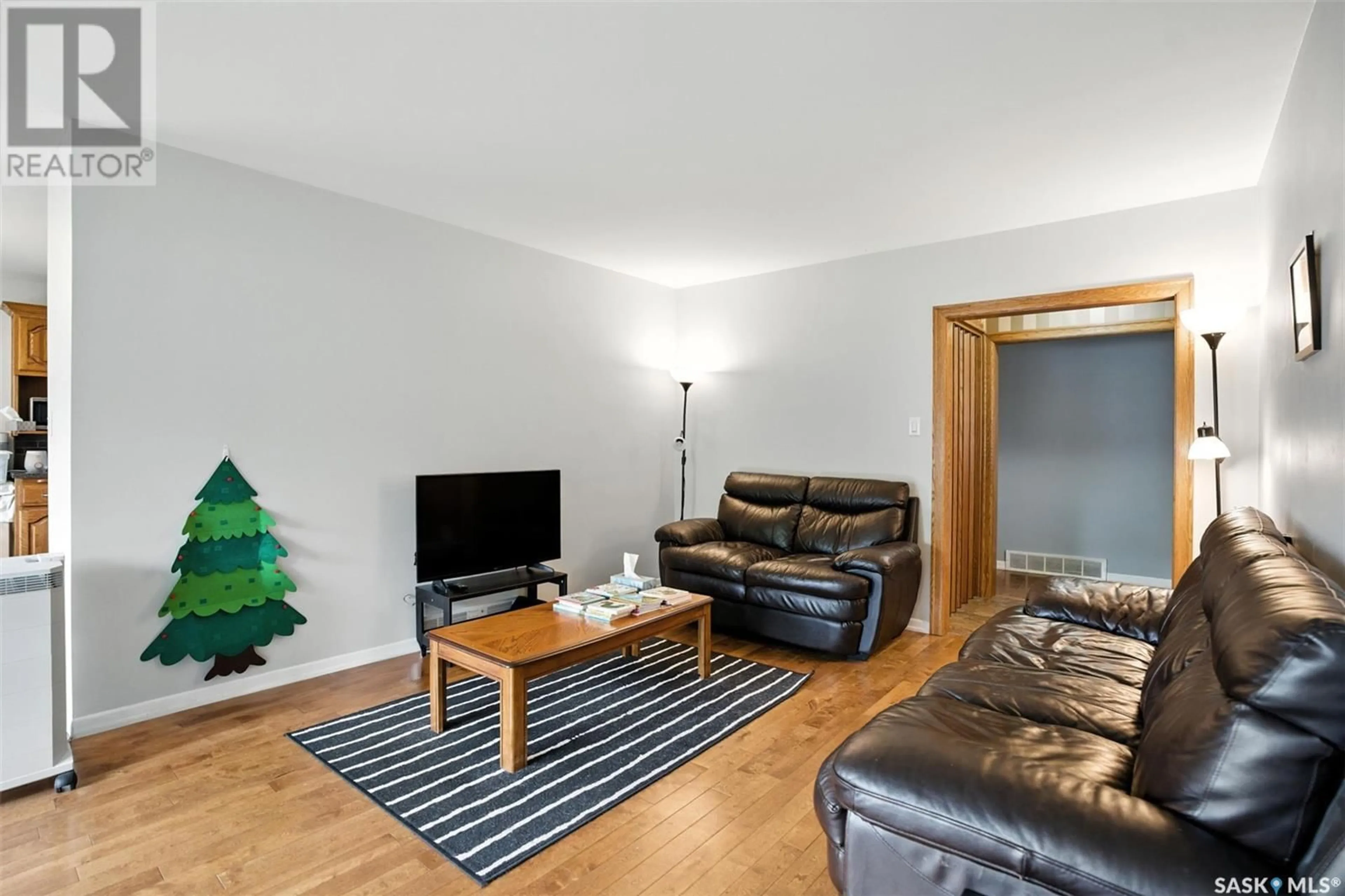 Living room with furniture, wood/laminate floor for 2118 HAULTAIN AVENUE, Saskatoon Saskatchewan S7J1P6