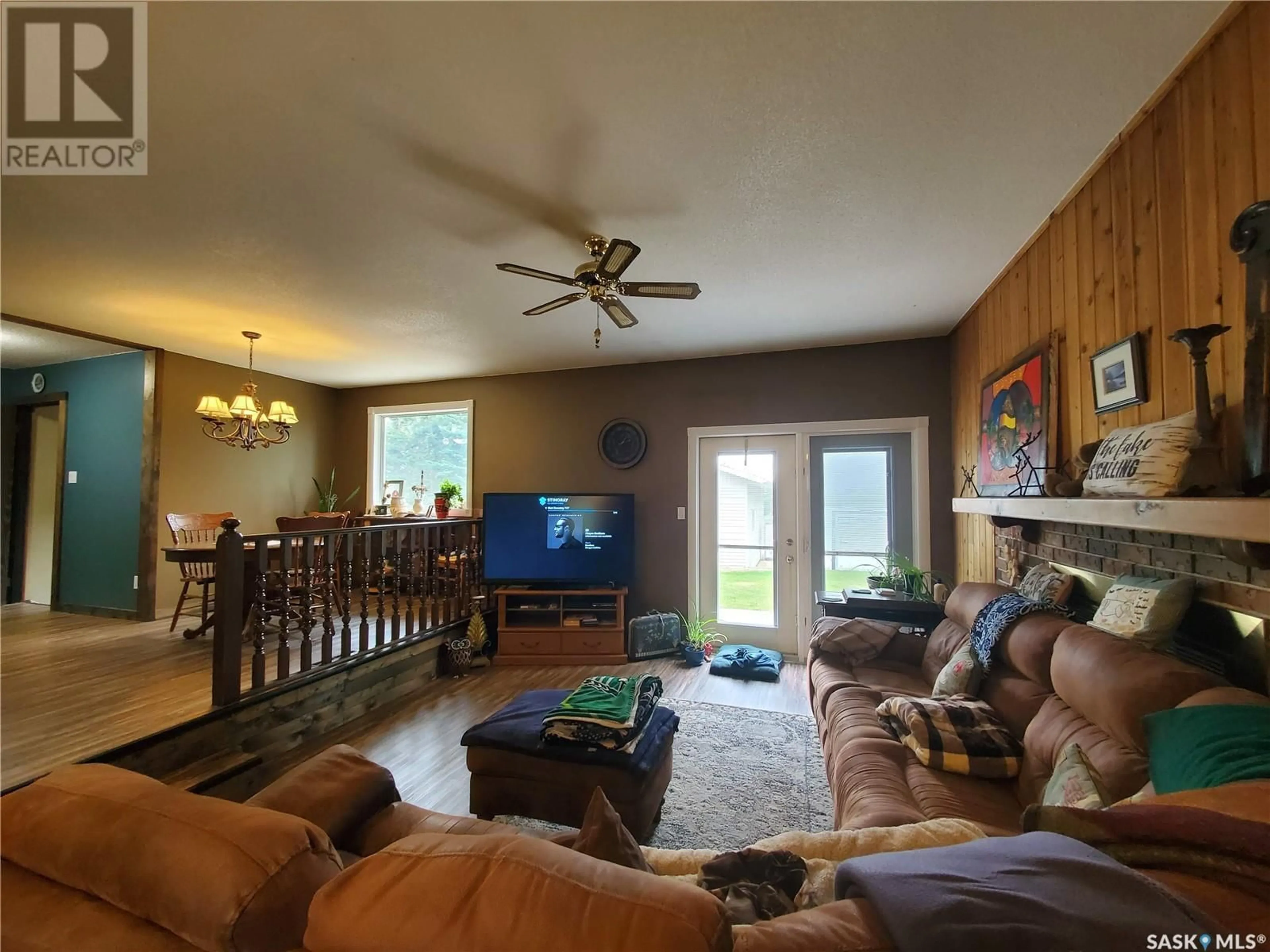 Living room with furniture, wood/laminate floor for 492 STEWART STREET, Kamsack Saskatchewan S0A1S0