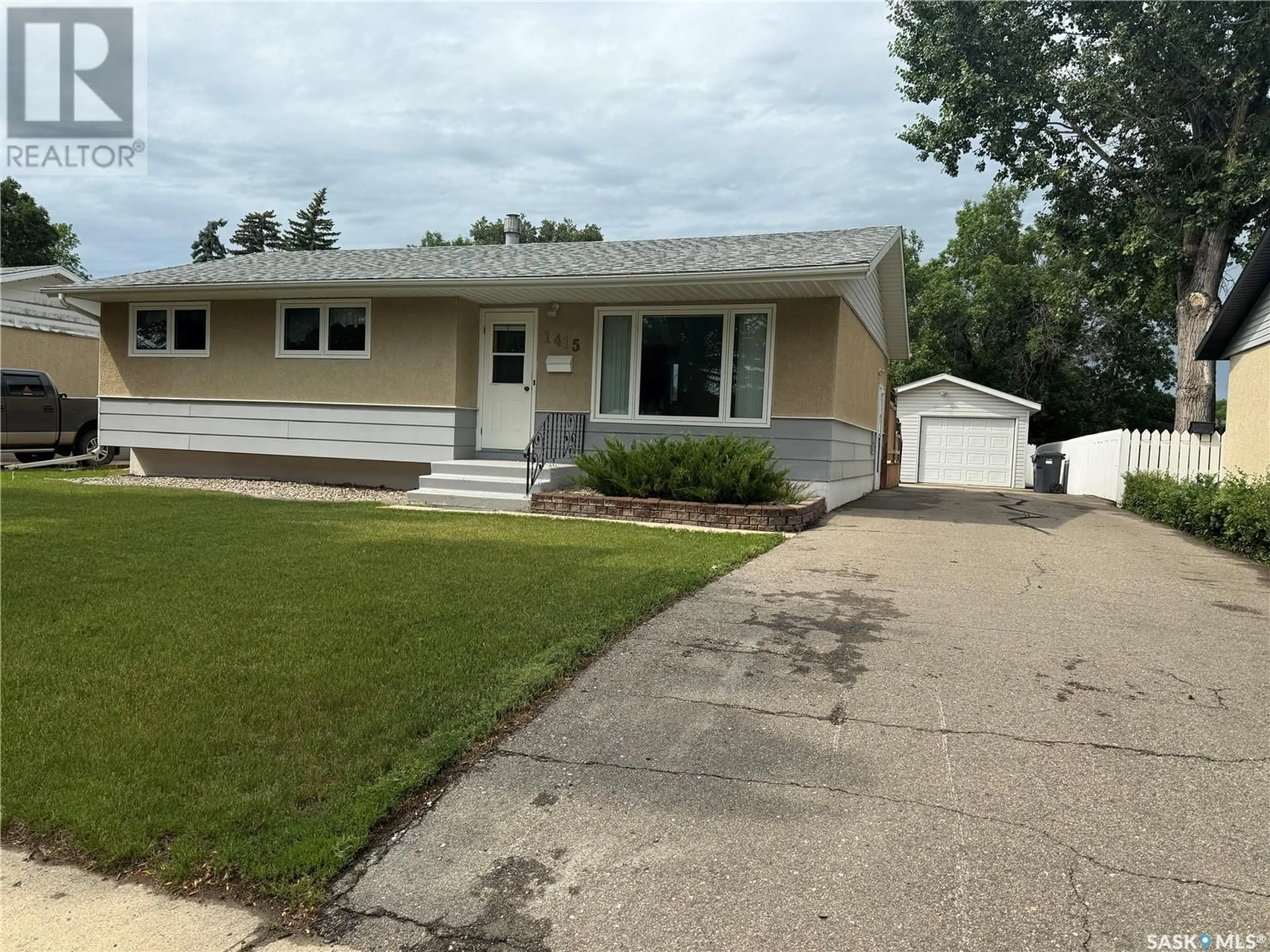 Home with vinyl exterior material, street for 1415 COTEAU AVENUE, Weyburn Saskatchewan S4H0H8