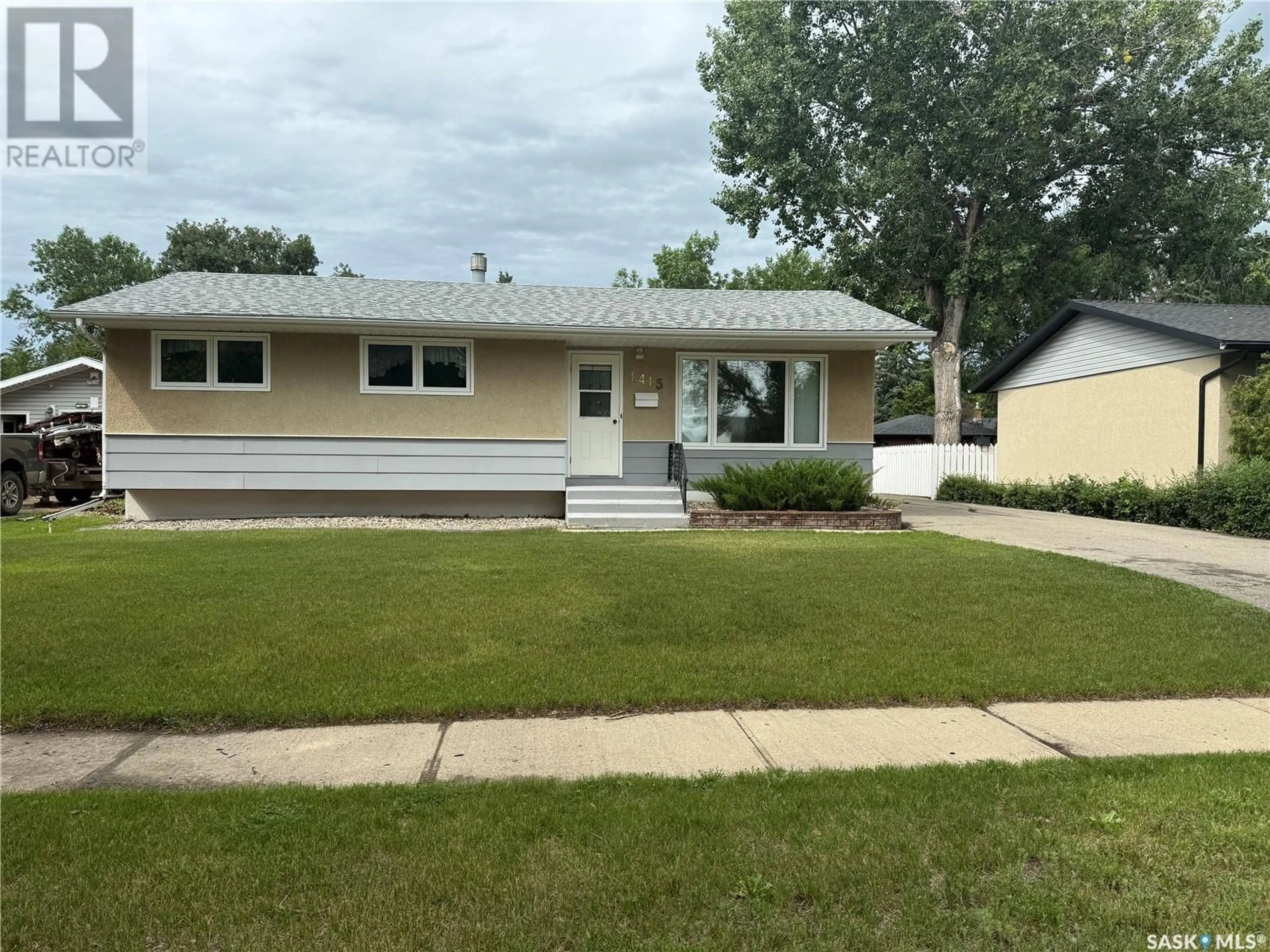Home with vinyl exterior material, street for 1415 COTEAU AVENUE, Weyburn Saskatchewan S4H0H8