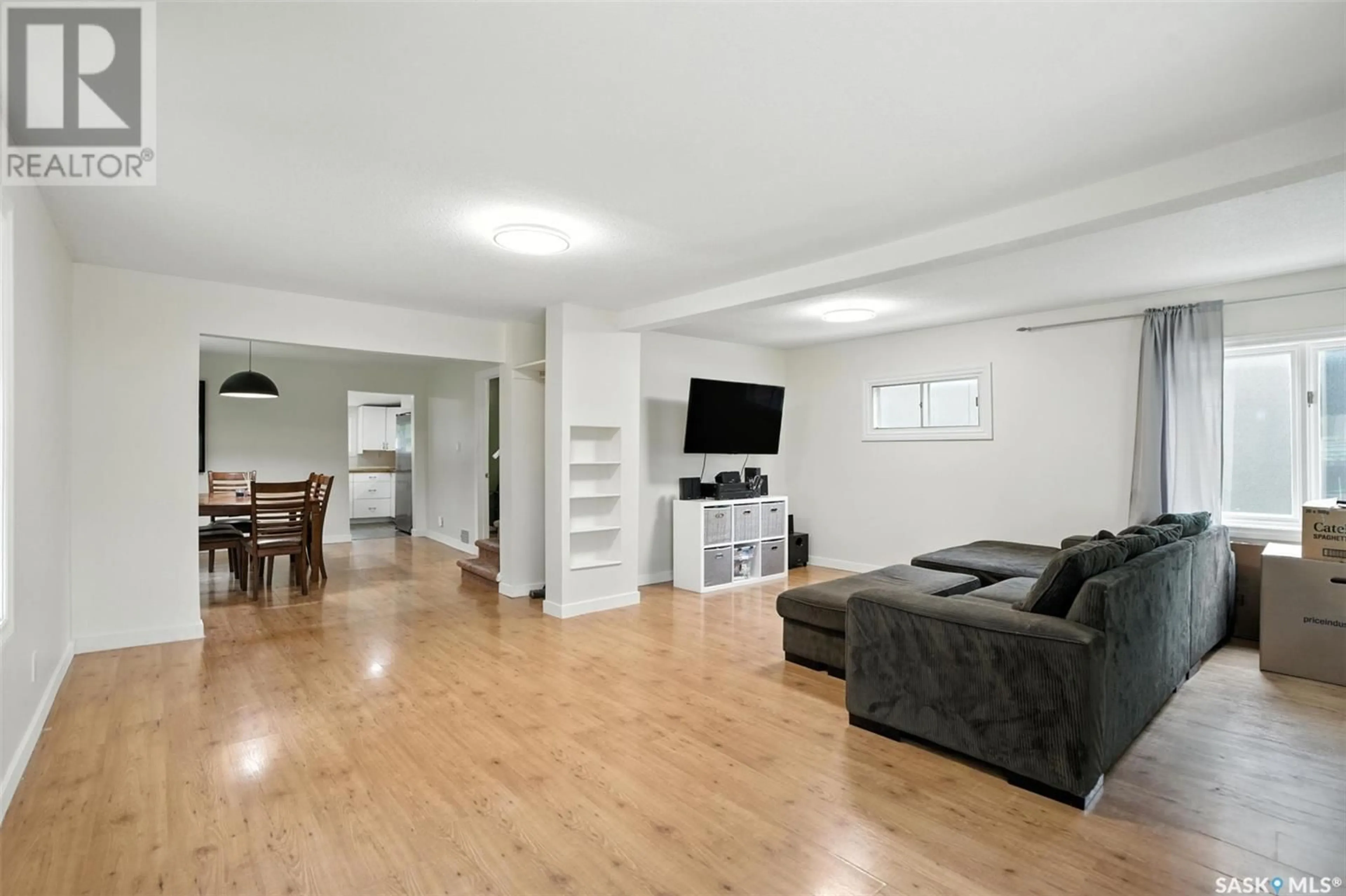Living room with furniture, wood/laminate floor for 1219 B AVENUE, Saskatoon Saskatchewan S7L1G4