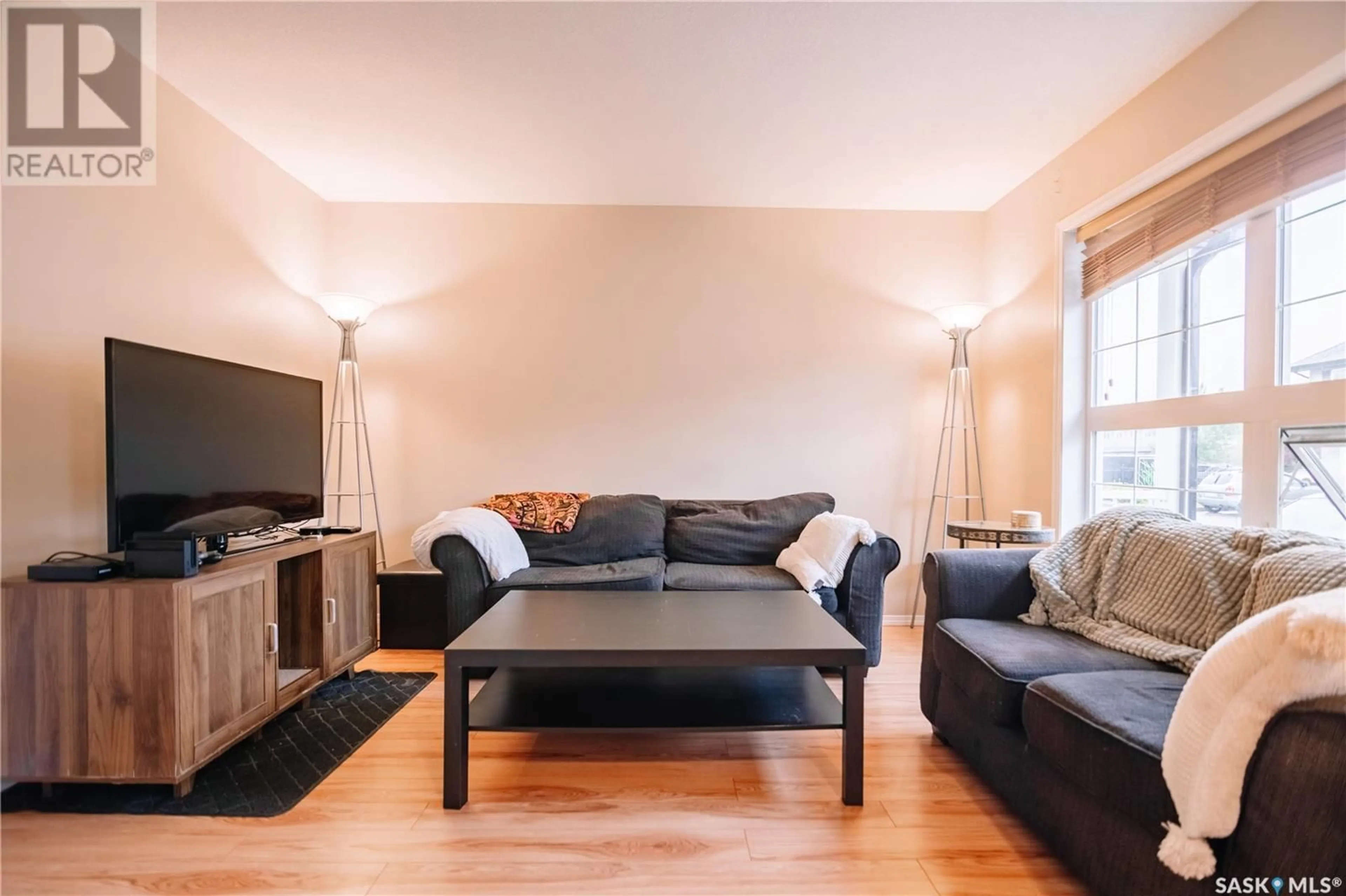 Living room with furniture, wood/laminate floor for 4500 - 34 CHILD AVENUE, Regina Saskatchewan S4X0A8