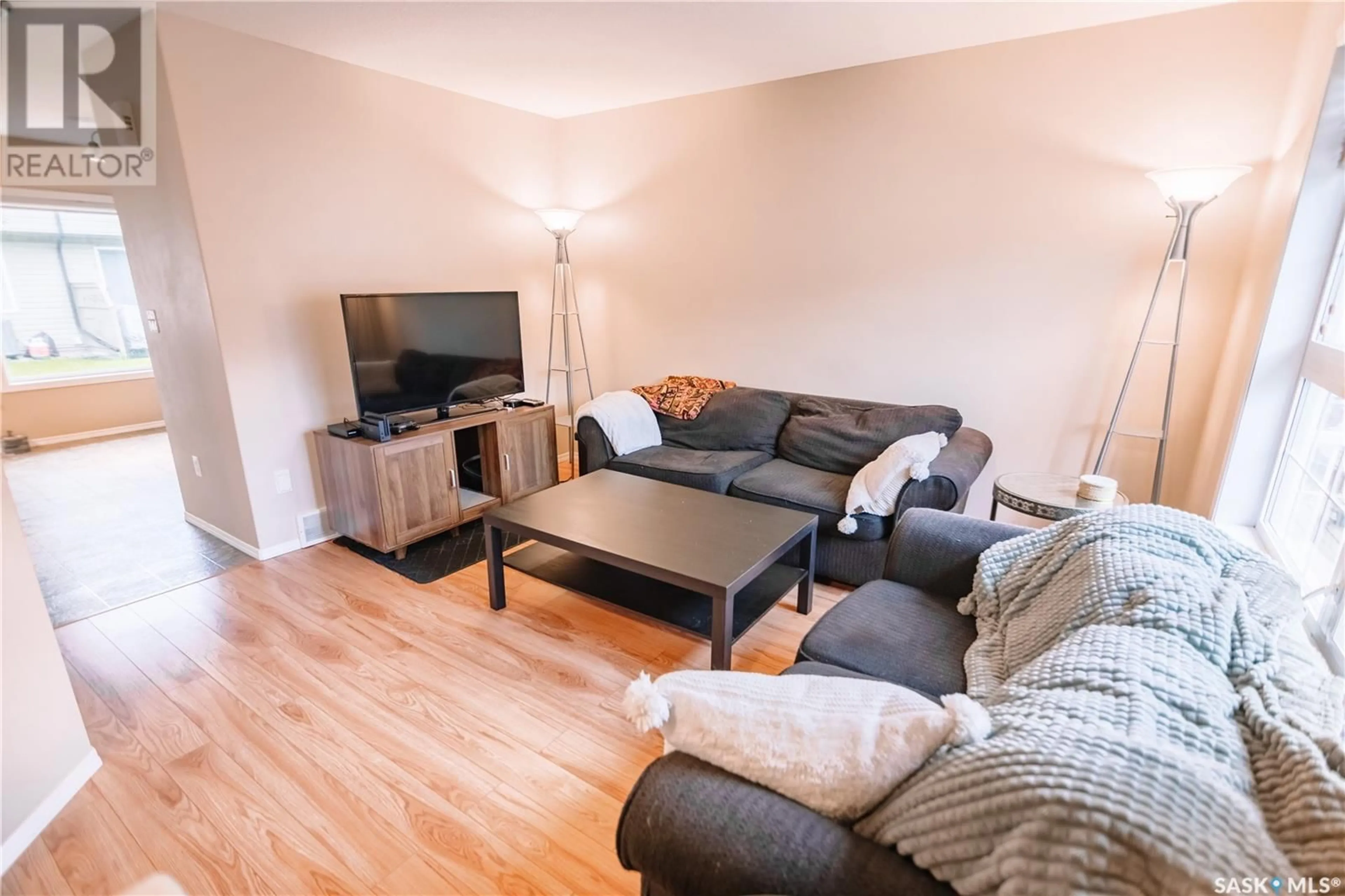 Living room with furniture, wood/laminate floor for 4500 - 34 CHILD AVENUE, Regina Saskatchewan S4X0A8
