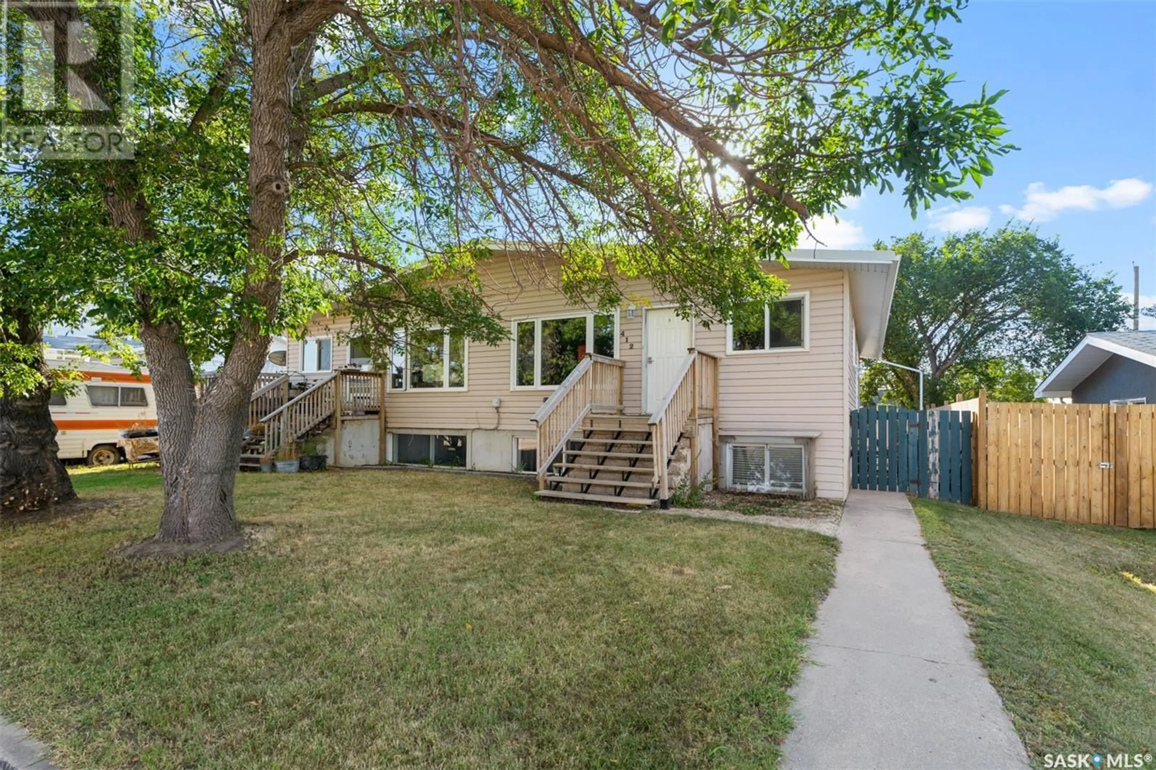 Home with vinyl exterior material, street for E - 410 - 412 3RD STREET, Delisle Saskatchewan S0L0P0