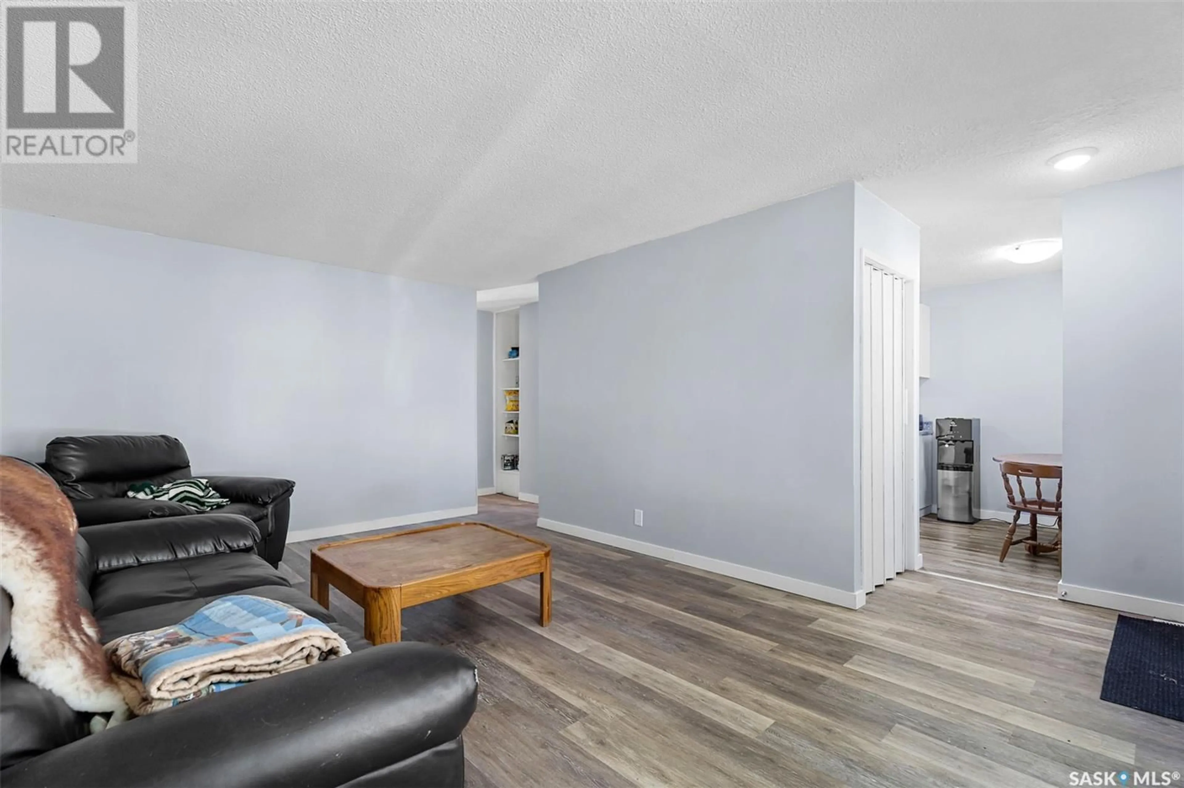 Living room with furniture, wood/laminate floor for E - 410 - 412 3RD STREET, Delisle Saskatchewan S0L0P0