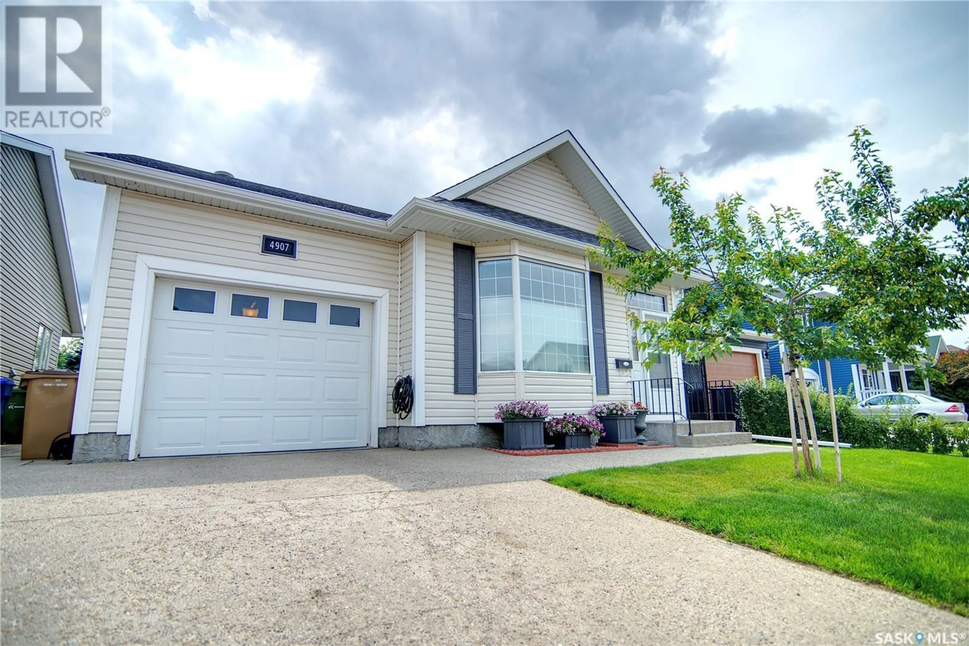 Home with vinyl exterior material, street for 4907 JUNIPER DRIVE, Regina Saskatchewan S4X4N8