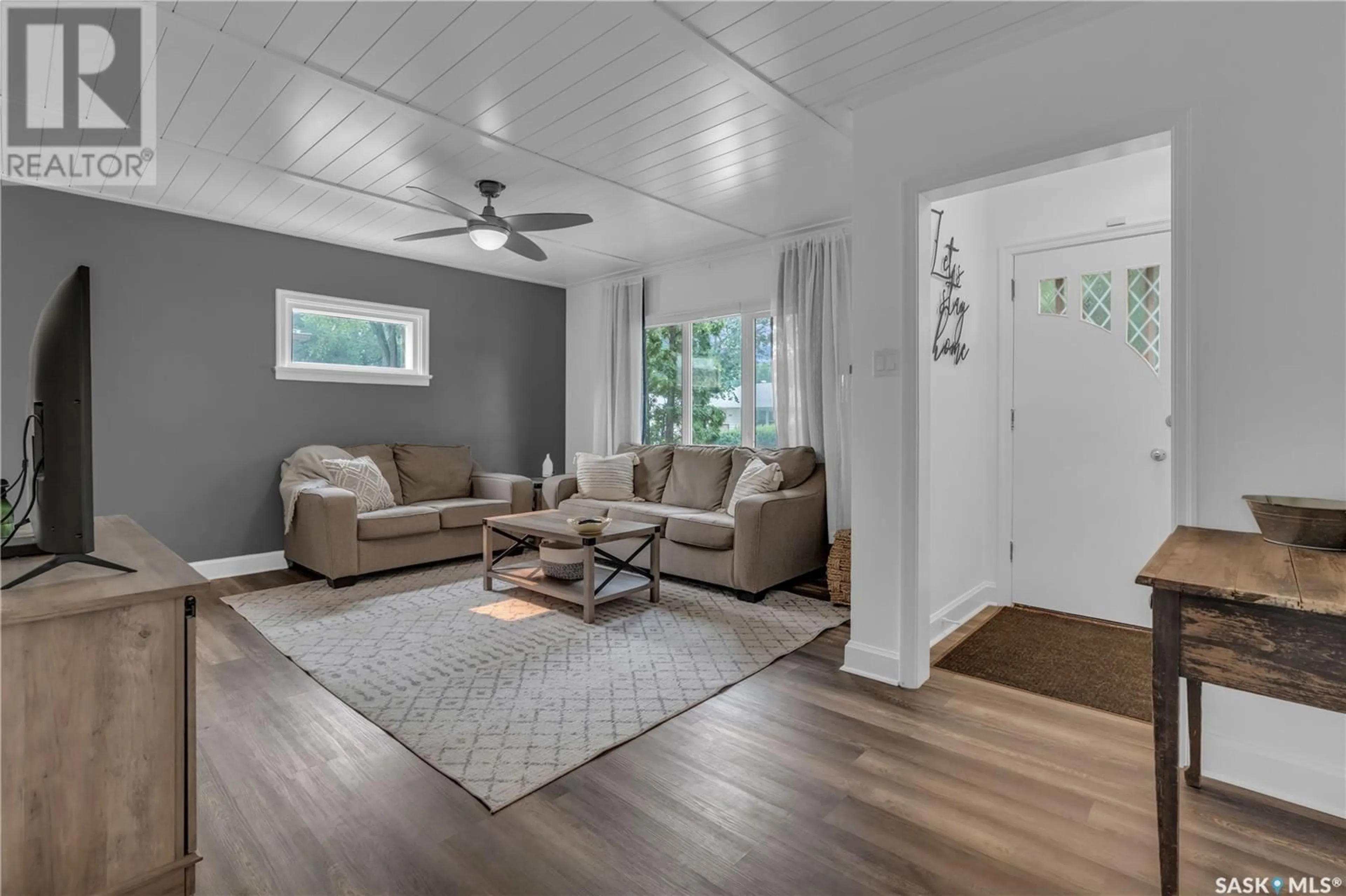 Living room with furniture, wood/laminate floor for 2709 THORNTON AVENUE, Regina Saskatchewan S4S1J2