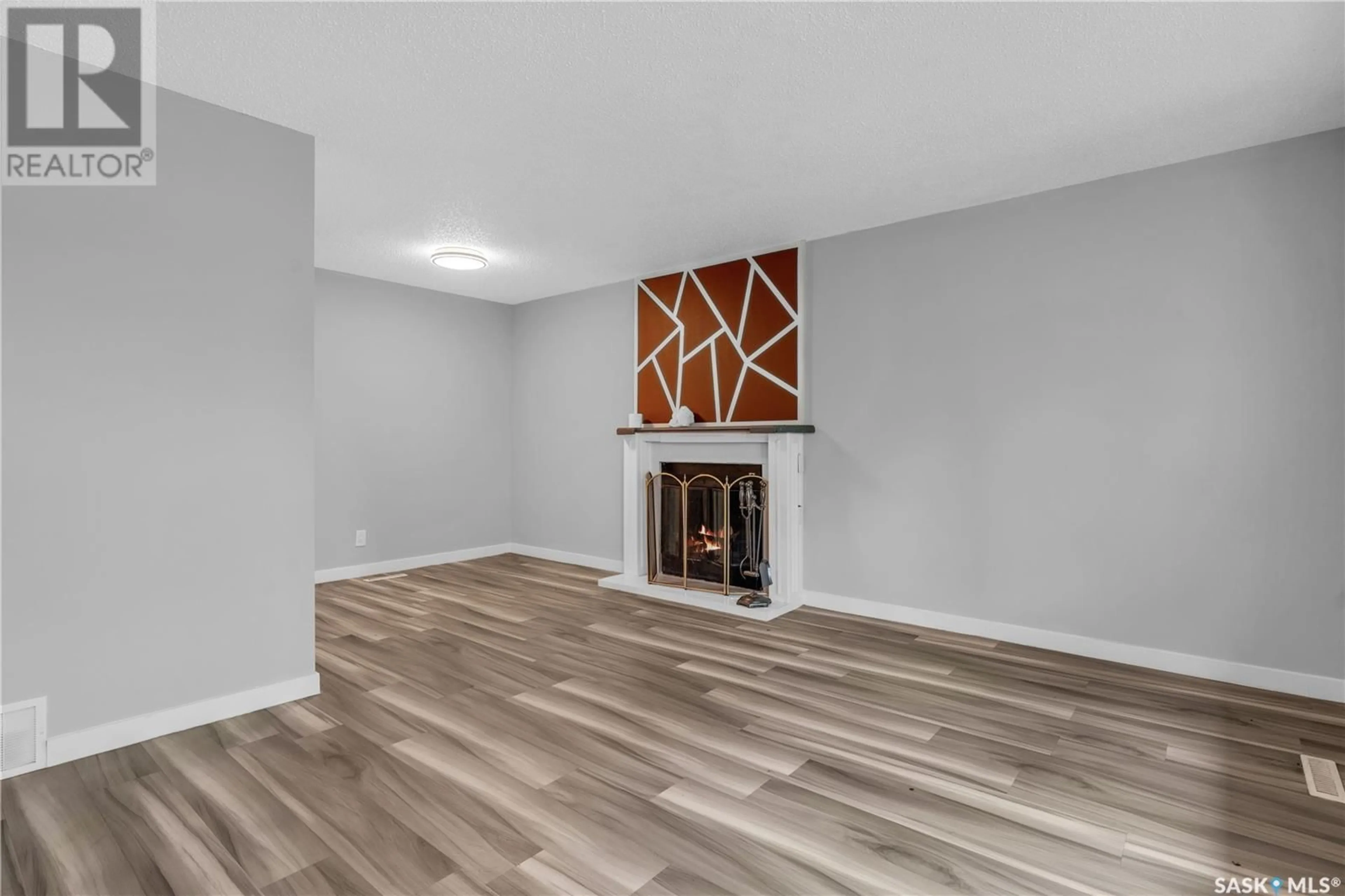 Living room with furniture, wood/laminate floor for 1721 E AVENUE N, Saskatoon Saskatchewan S7L1V3