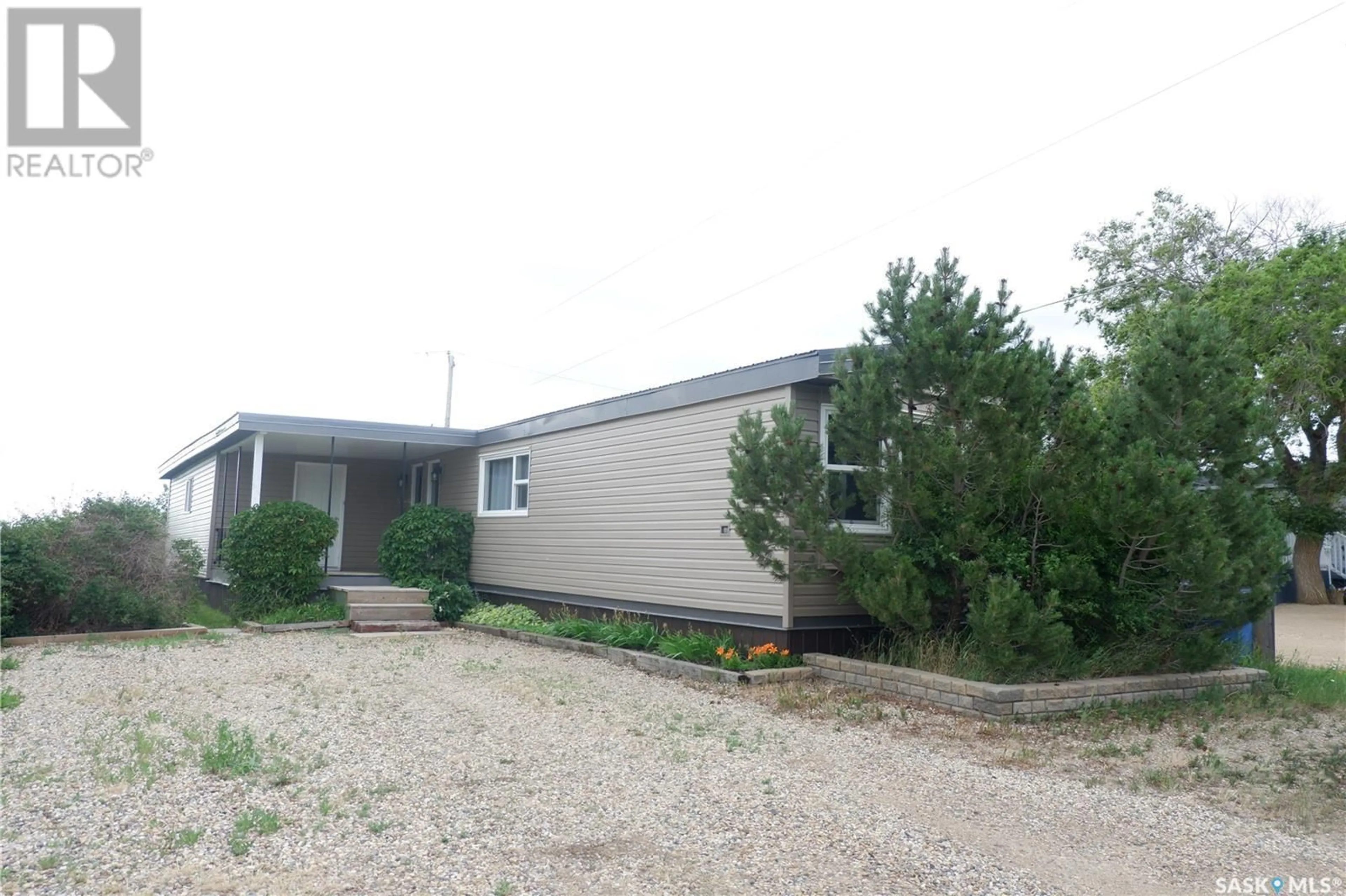 Home with vinyl exterior material, street for 67 SUNRISE ESTATES, Assiniboia Saskatchewan S0H0B0