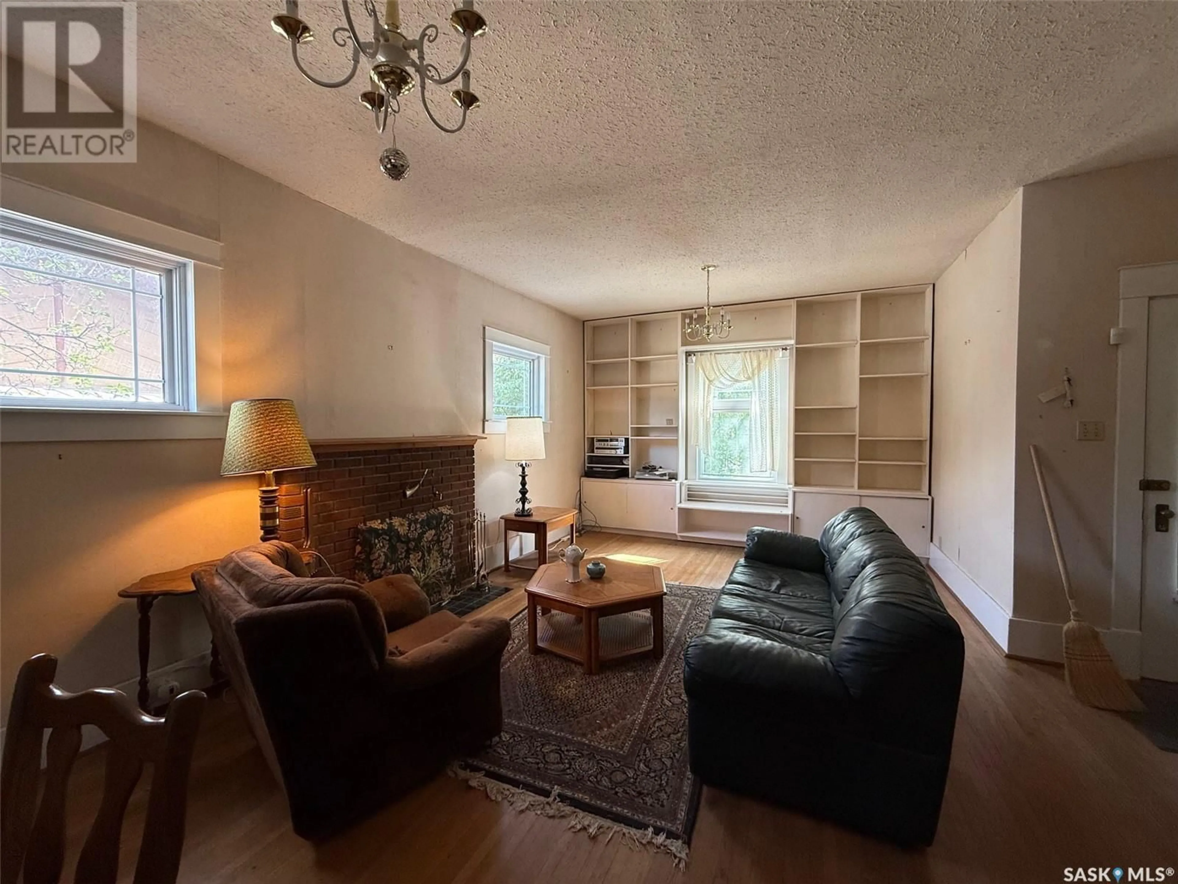 Living room with furniture, wood/laminate floor for 1401 107TH STREET, North Battleford Saskatchewan S9A1Z8