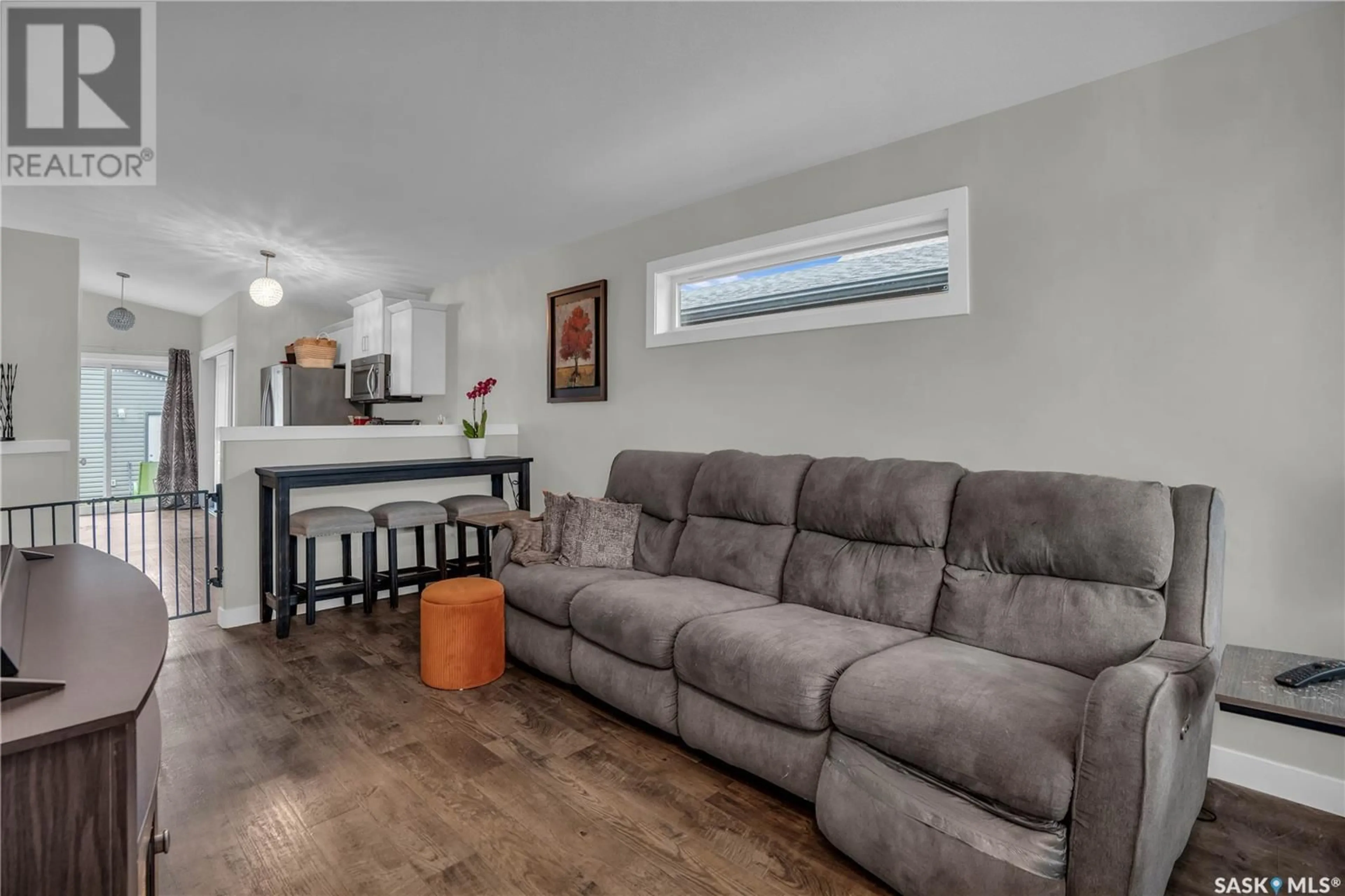 Living room with furniture, wood/laminate floor for 5413 CAMPLING AVENUE, Regina Saskatchewan S4W0L5