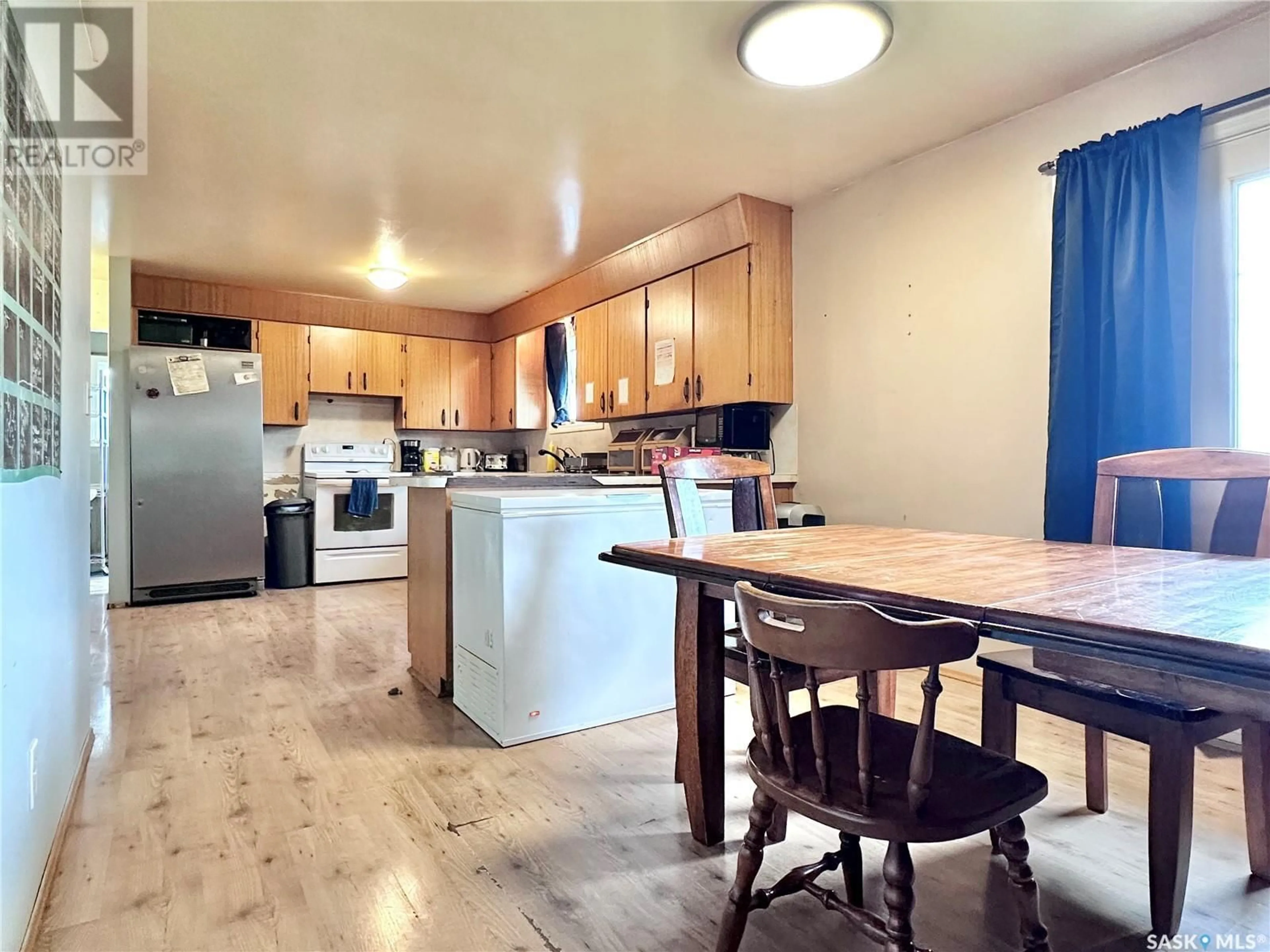 Open concept kitchen, wood/laminate floor for HUSSEY ACREAGE, Marriott Rm No. 317 Saskatchewan S0L2V0