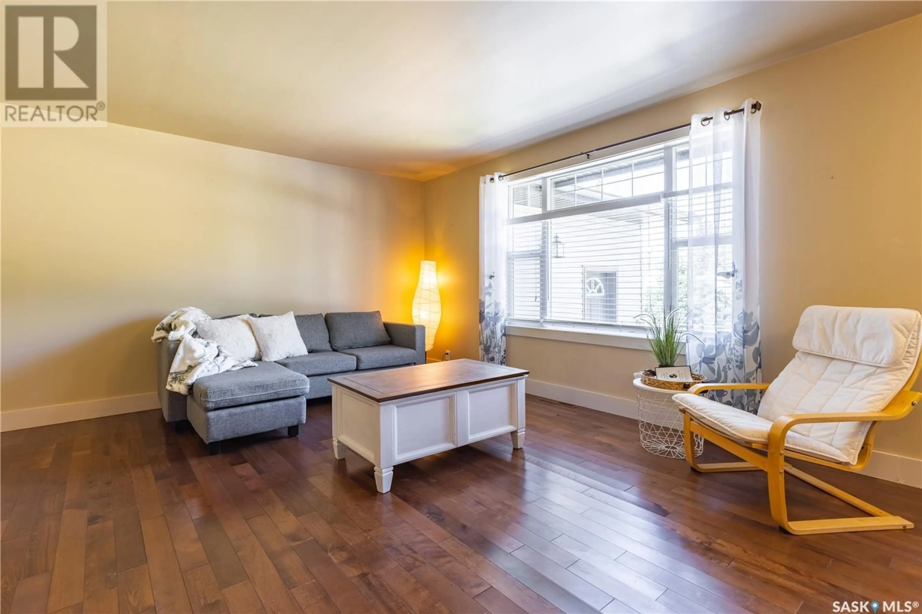 Living room with furniture, wood/laminate floor for 607 1ST STREET, Kenaston Saskatchewan S0G2N0