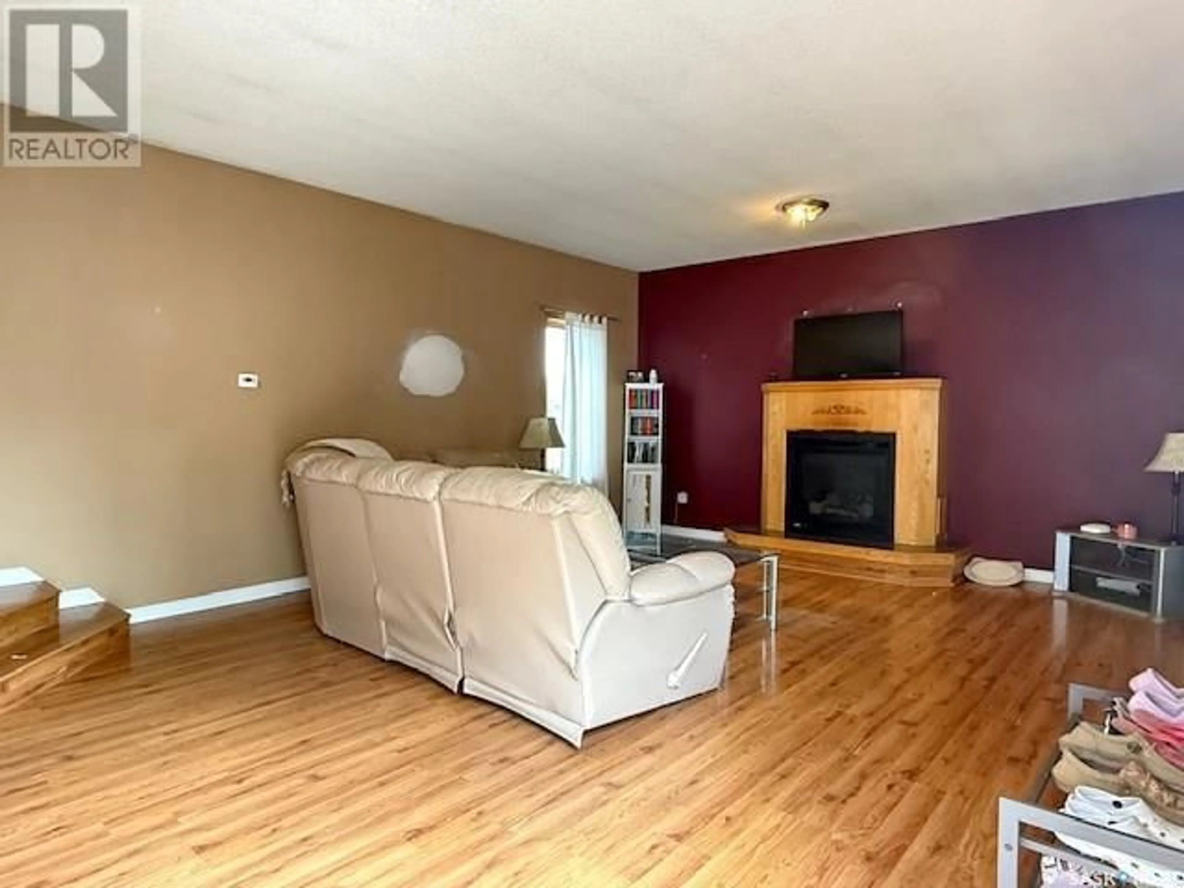 Living room with furniture, wood/laminate floor for 620 MAIN STREET, Melville Saskatchewan S0A2P0