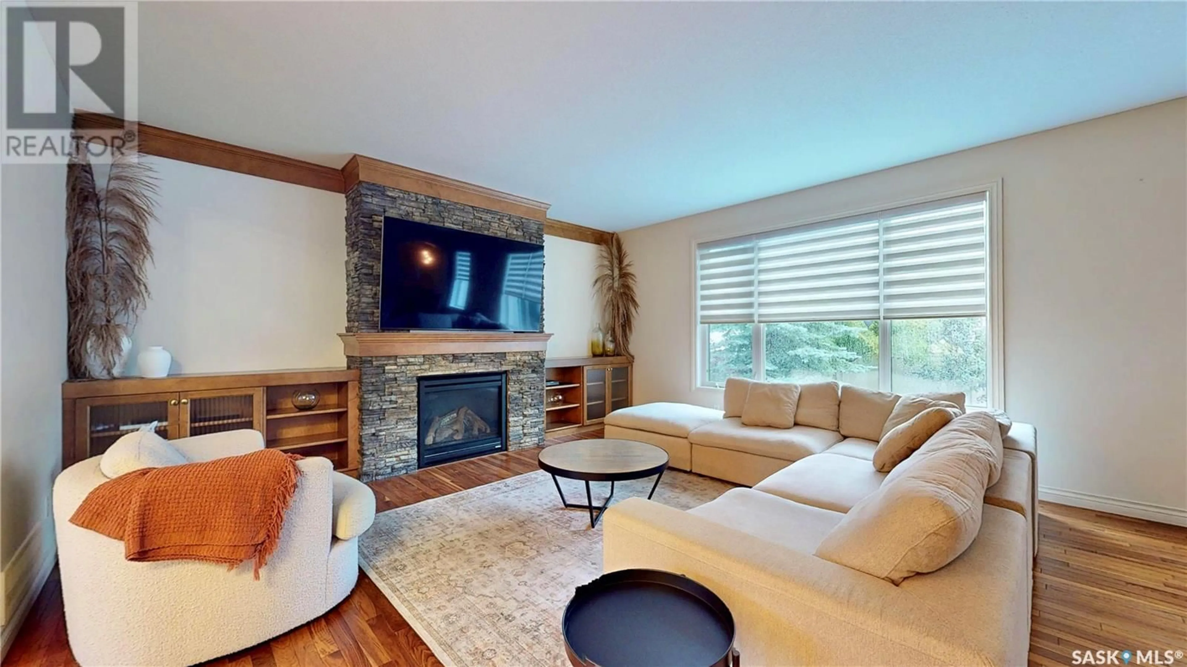 Living room with furniture, wood/laminate floor for 8322 WASCANA GARDENS WAY, Regina Saskatchewan S4V1E9