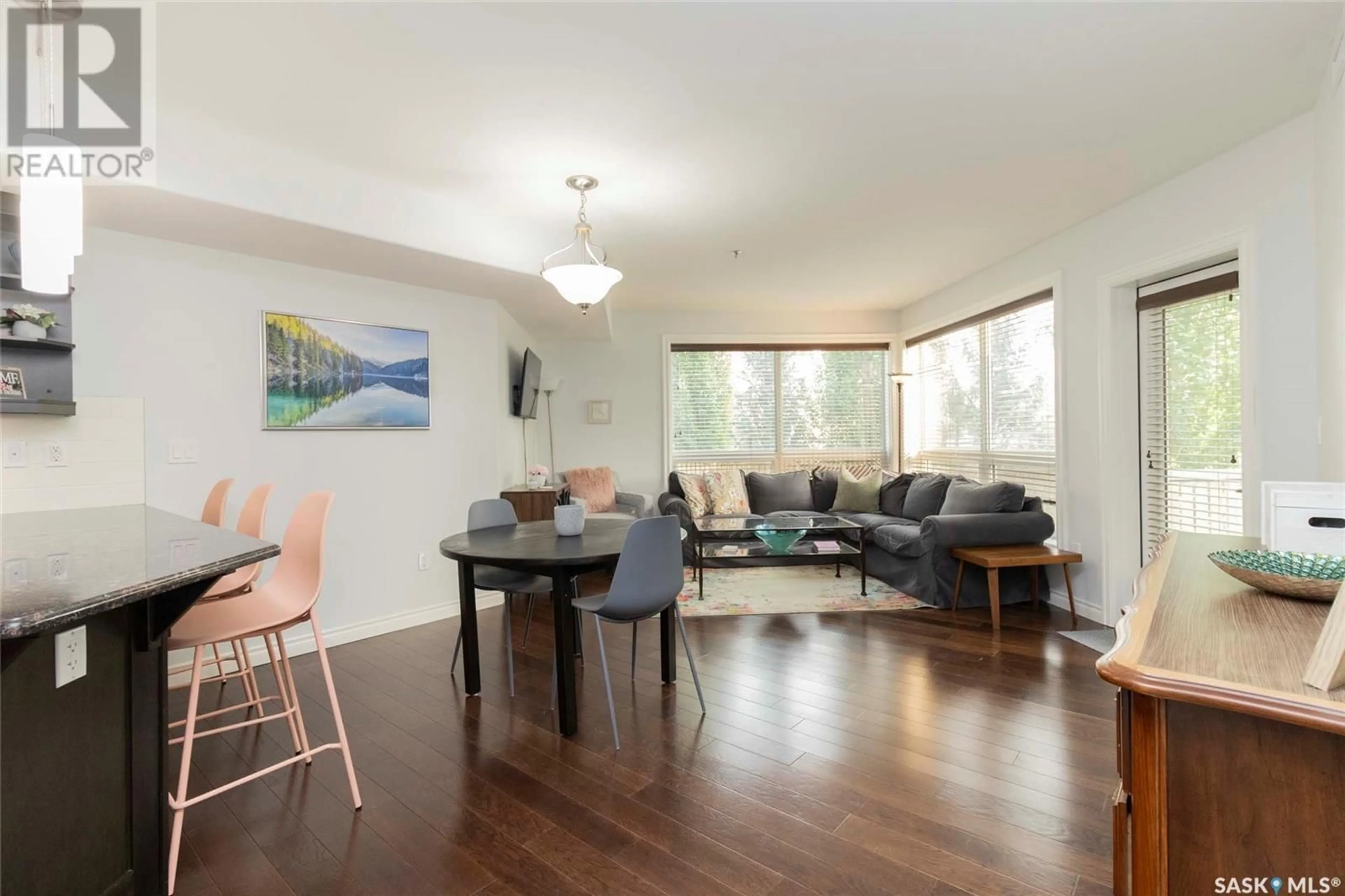 Living room with furniture, wood/laminate floor for 104 - 227 PINEHOUSE DRIVE, Saskatoon Saskatchewan S7K6N9