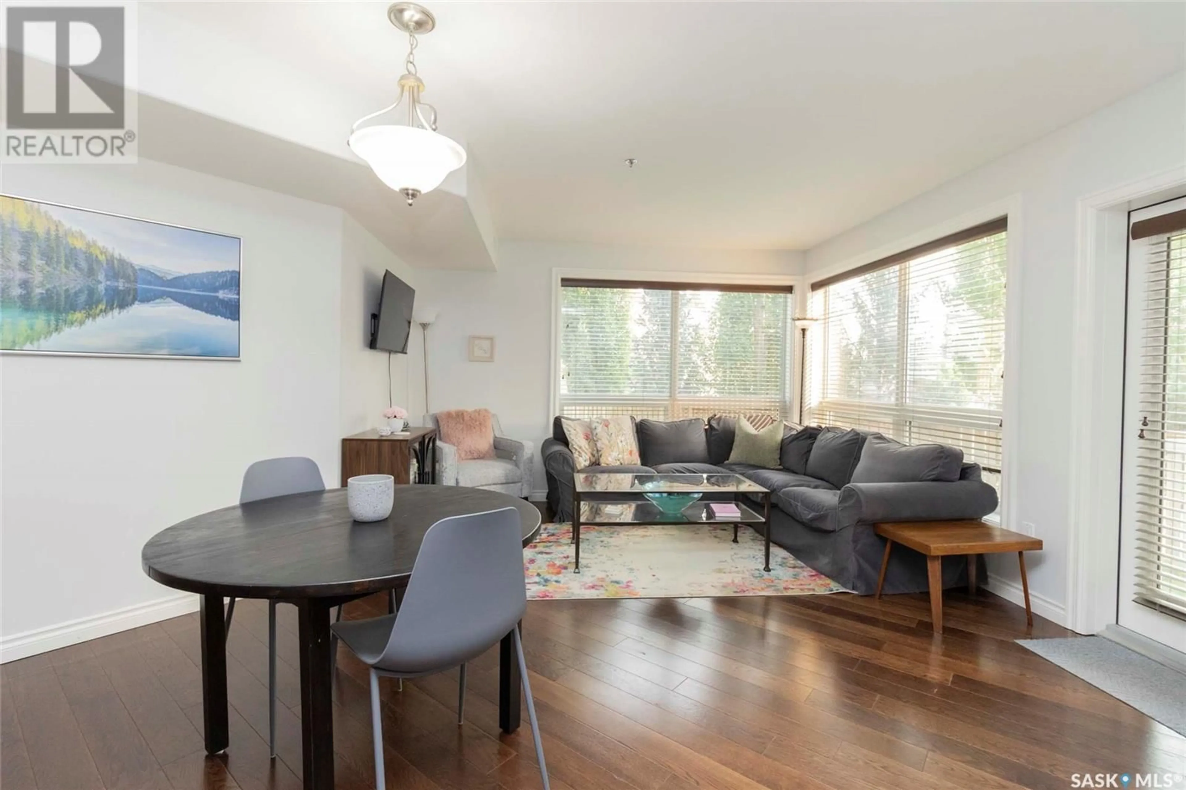 Living room with furniture, wood/laminate floor for 104 - 227 PINEHOUSE DRIVE, Saskatoon Saskatchewan S7K6N9
