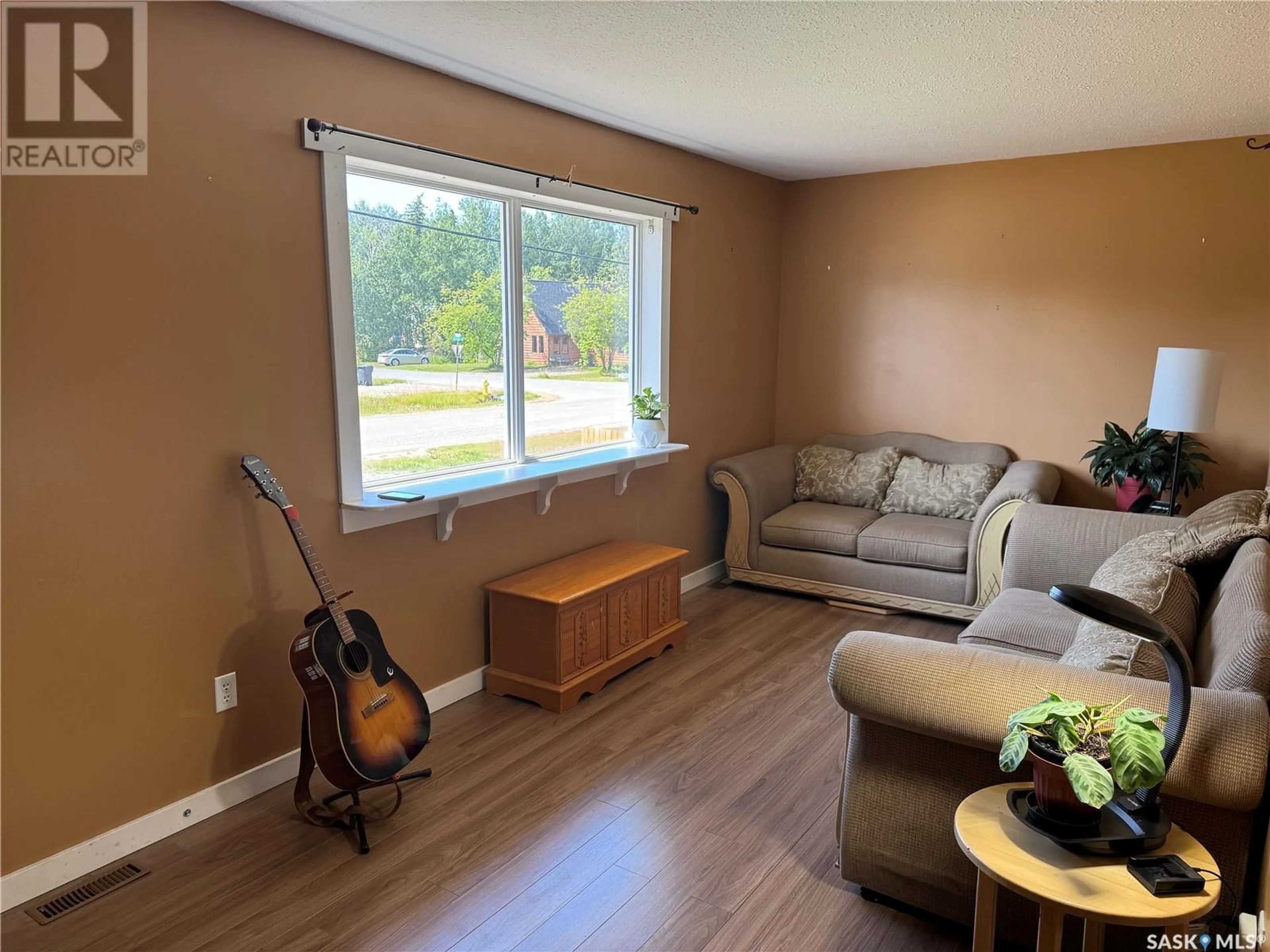 Living room with furniture, wood/laminate floor for 217 VICKERS CRESCENT, Air Ronge Saskatchewan S0J3G0