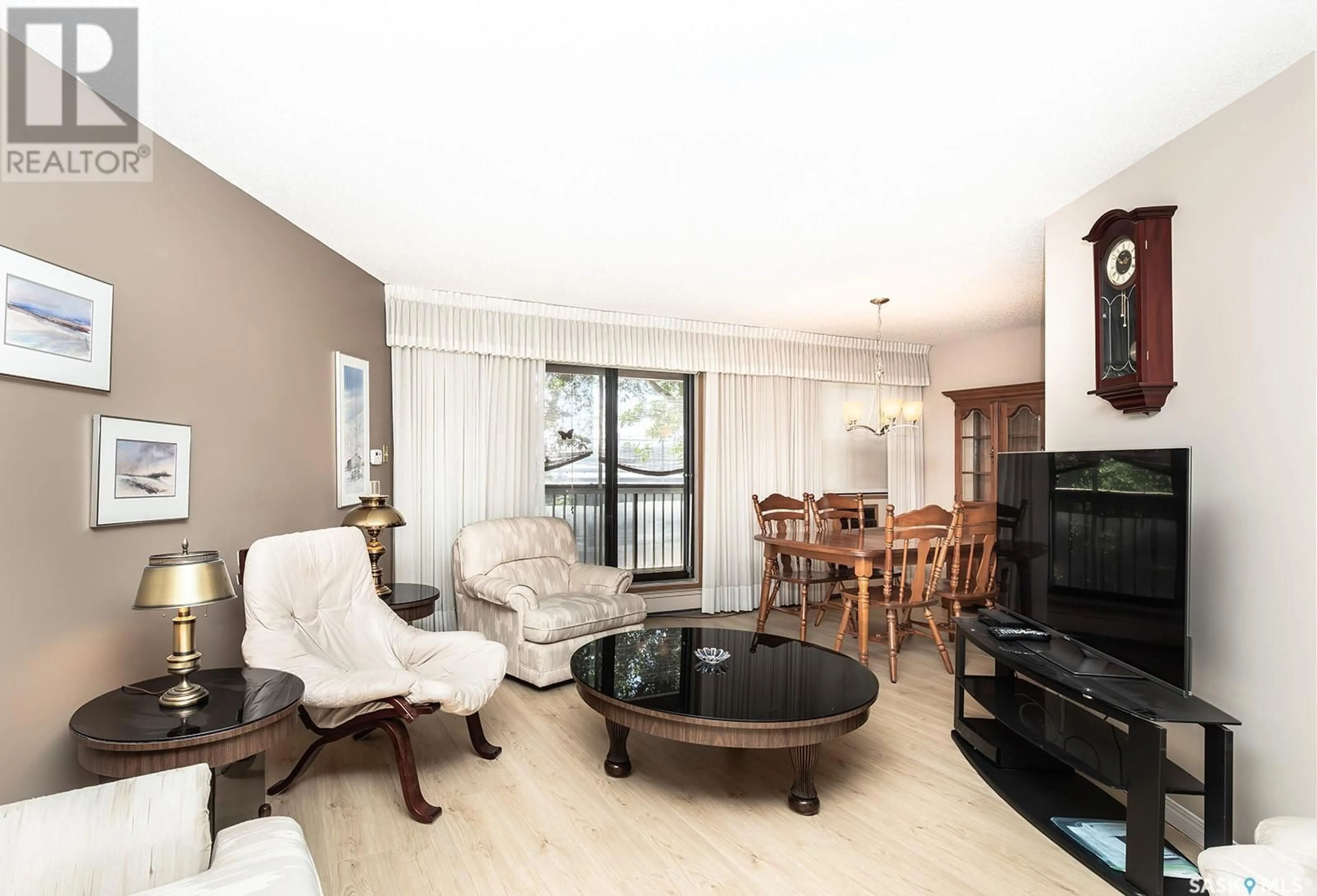 Living room with furniture, wood/laminate floor for 308 - 525 5TH AVENUE, Saskatoon Saskatchewan S7K2R1