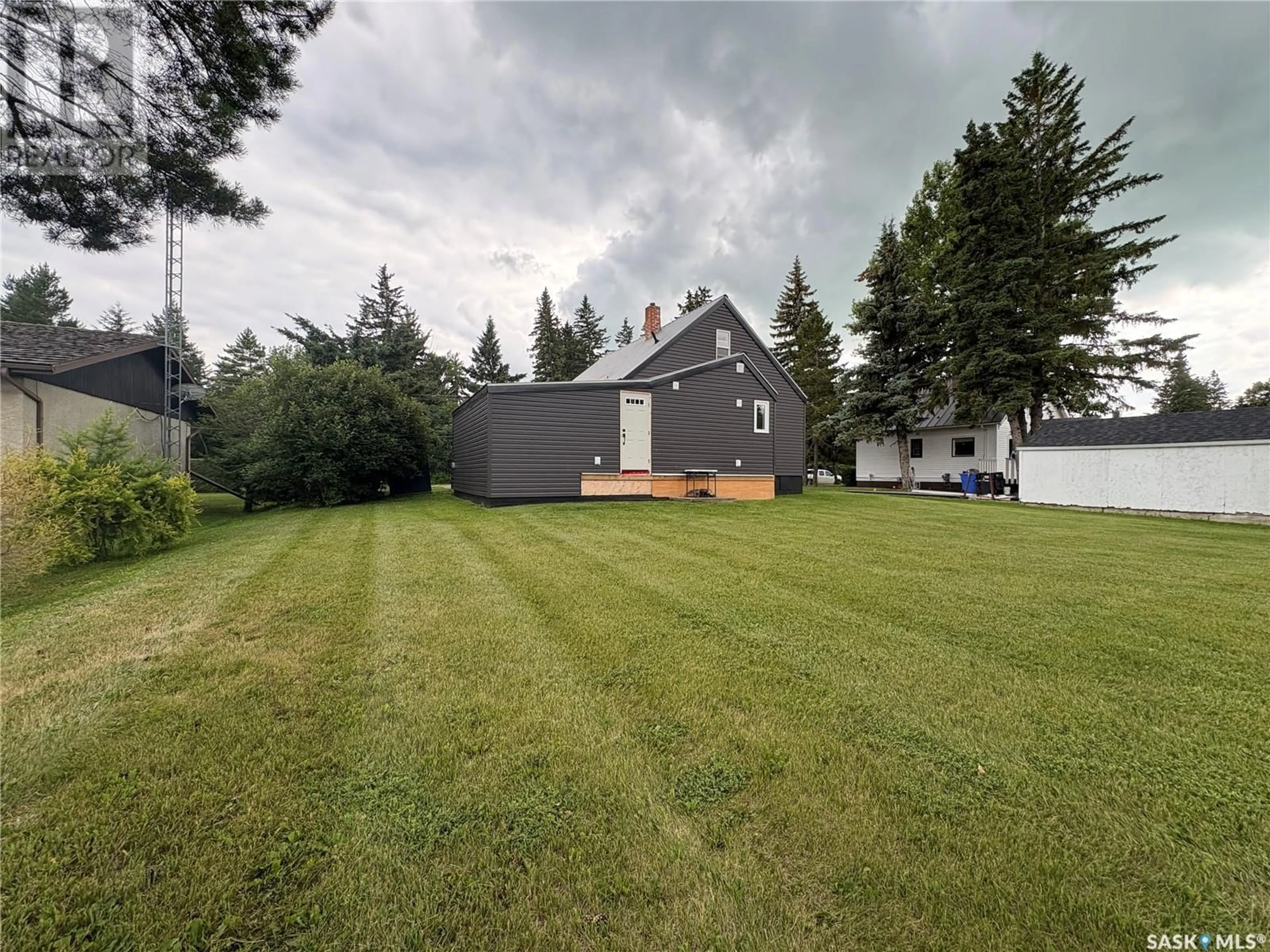 A pic from outside/outdoor area/front of a property/back of a property/a pic from drone, unknown for E - 212 RIEDEL AVENUE, Langenburg Saskatchewan S0A2A0