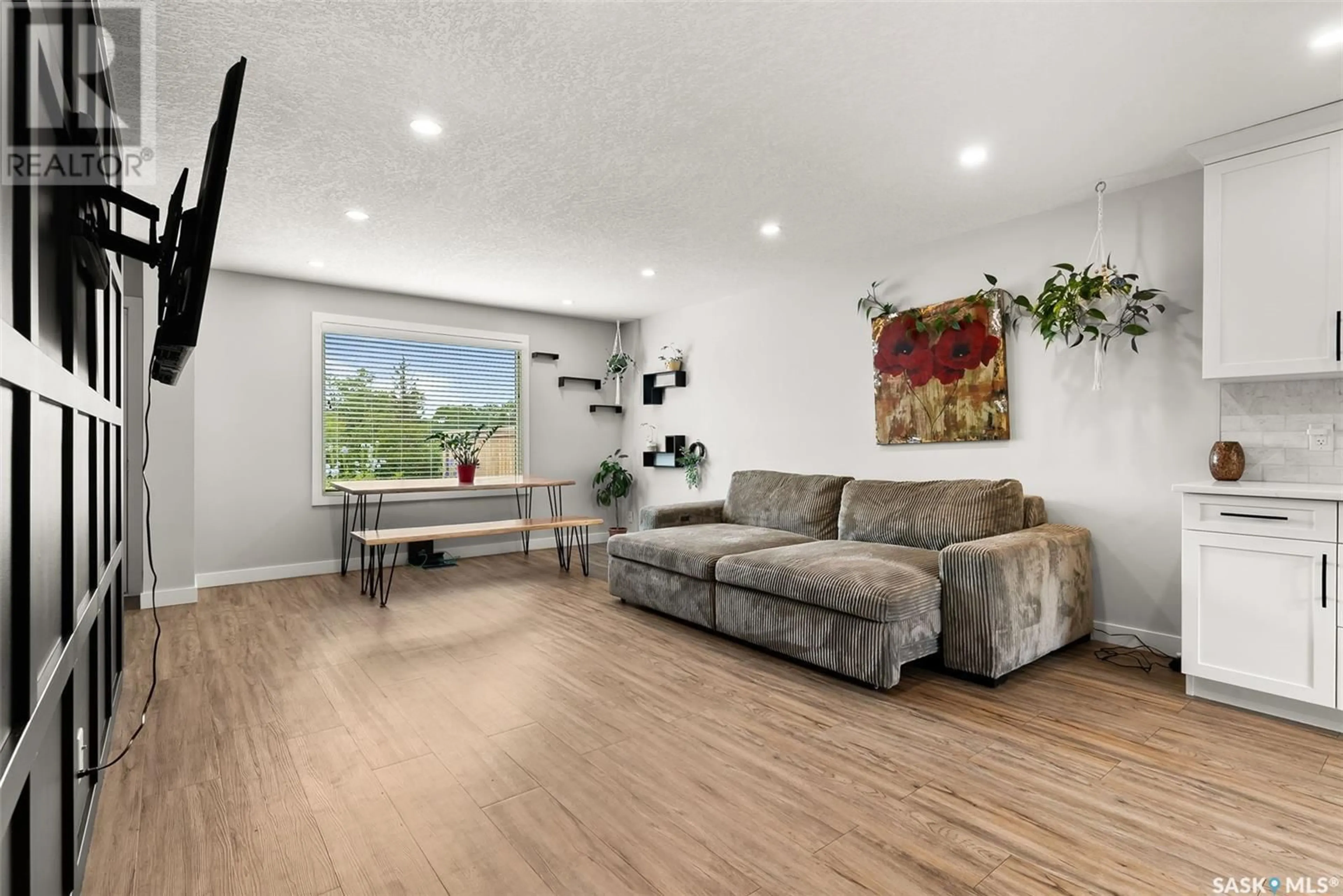 Living room with furniture, wood/laminate floor for 107 KILLARNEY WAY, Regina Saskatchewan S4S6X8