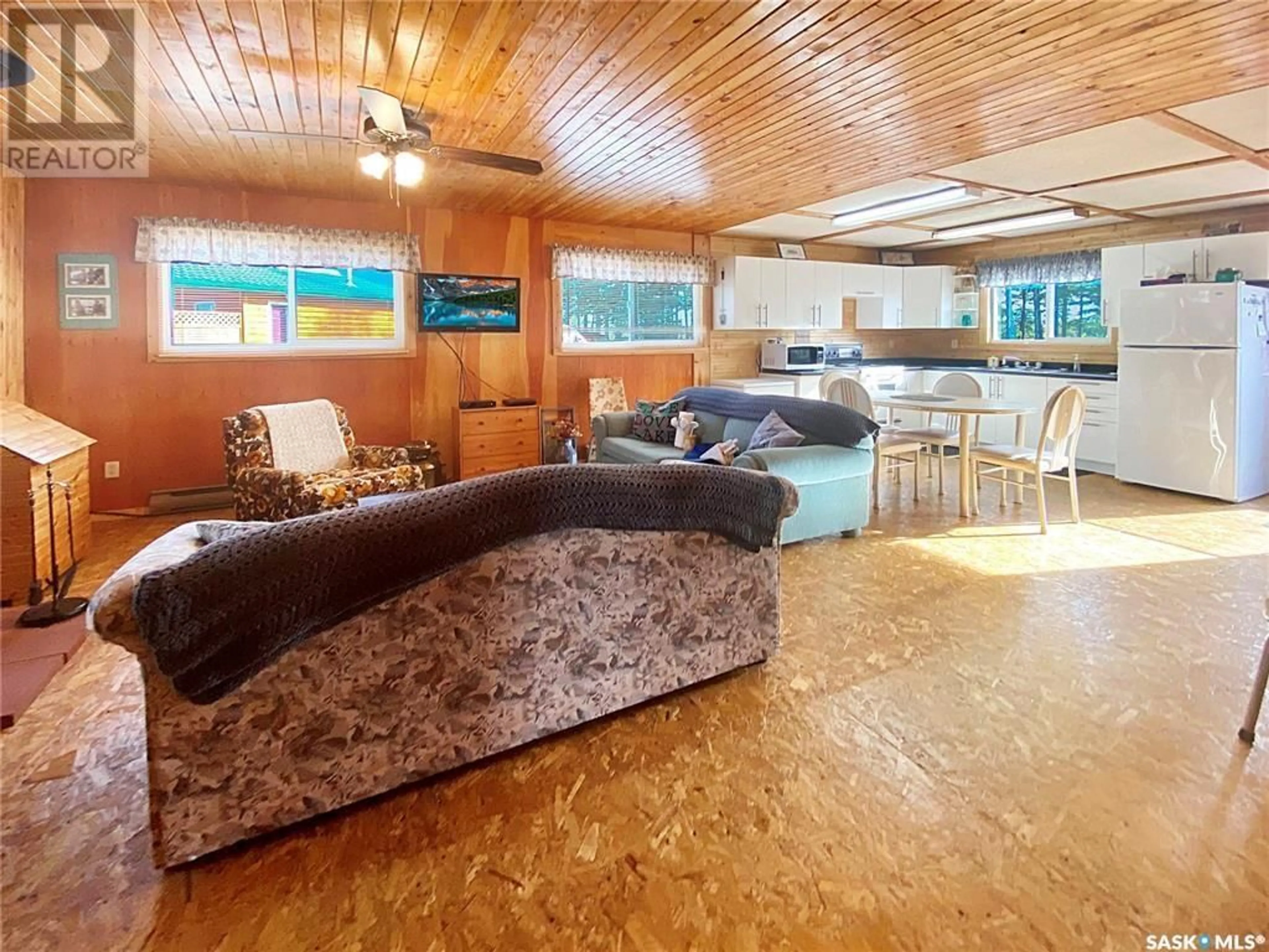 Living room with furniture, wood/laminate floor for 11 NORLAND PLACE, Candle Lake Saskatchewan S0J3E0