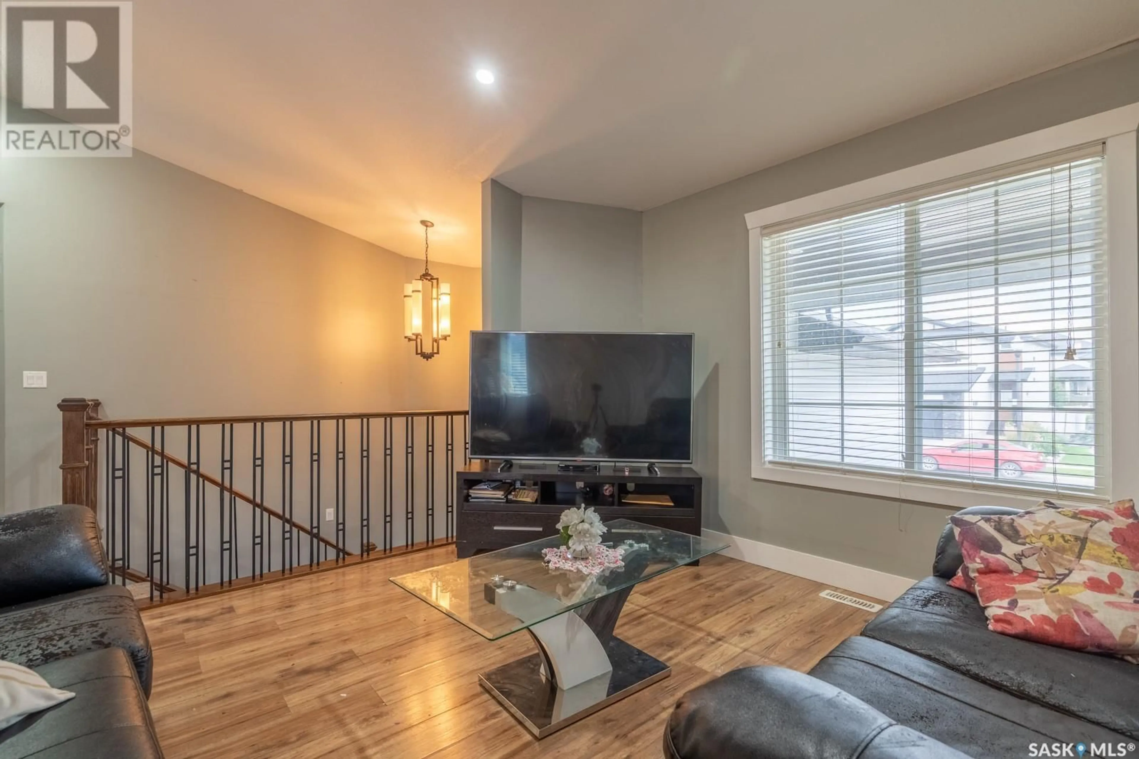 Living room with furniture, wood/laminate floor for 5201 AVIATOR CRESCENT, Regina Saskatchewan S4W0G6