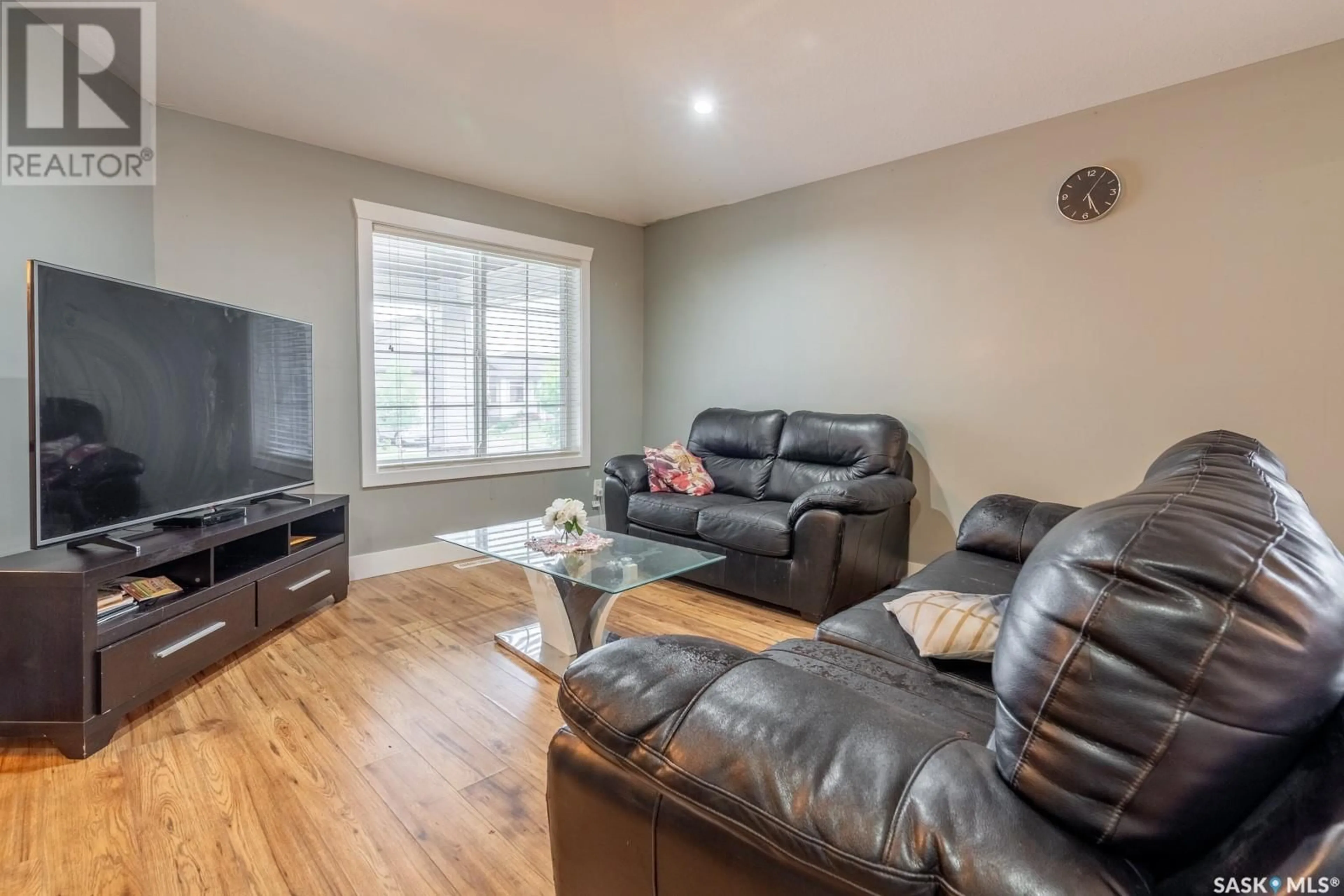 Living room with furniture, wood/laminate floor for 5201 AVIATOR CRESCENT, Regina Saskatchewan S4W0G6