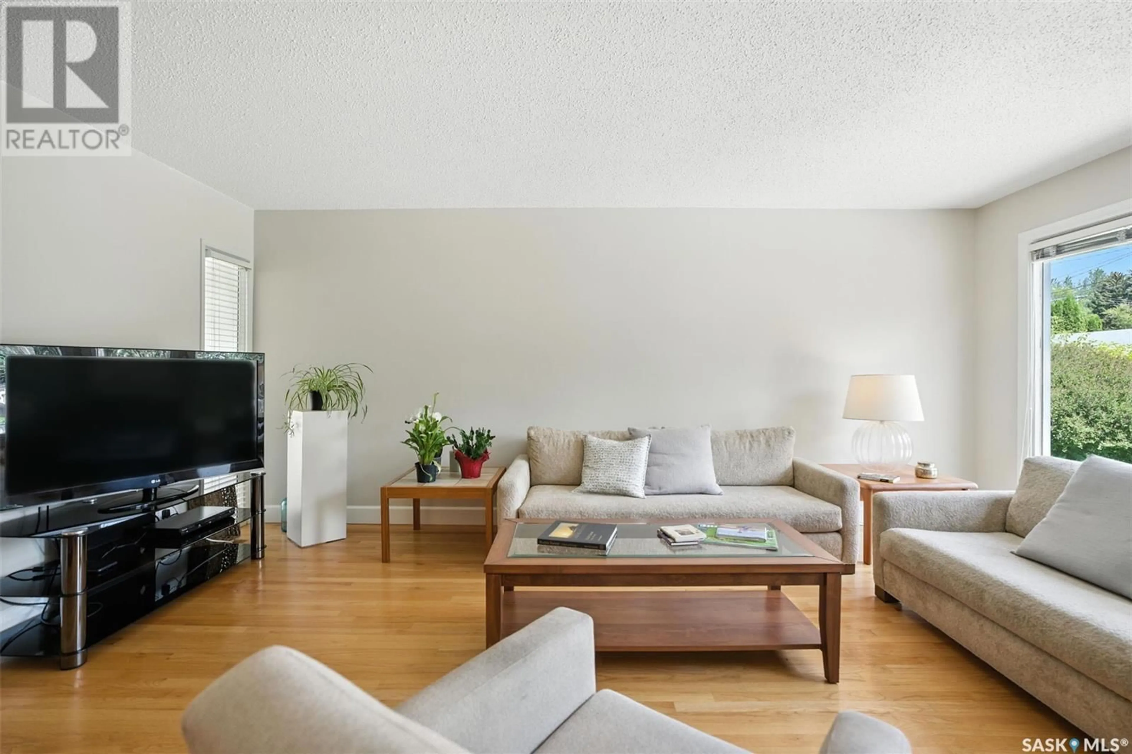Living room with furniture, wood/laminate floor for 1309 PARK AVENUE, Saskatoon Saskatchewan S7H2N7