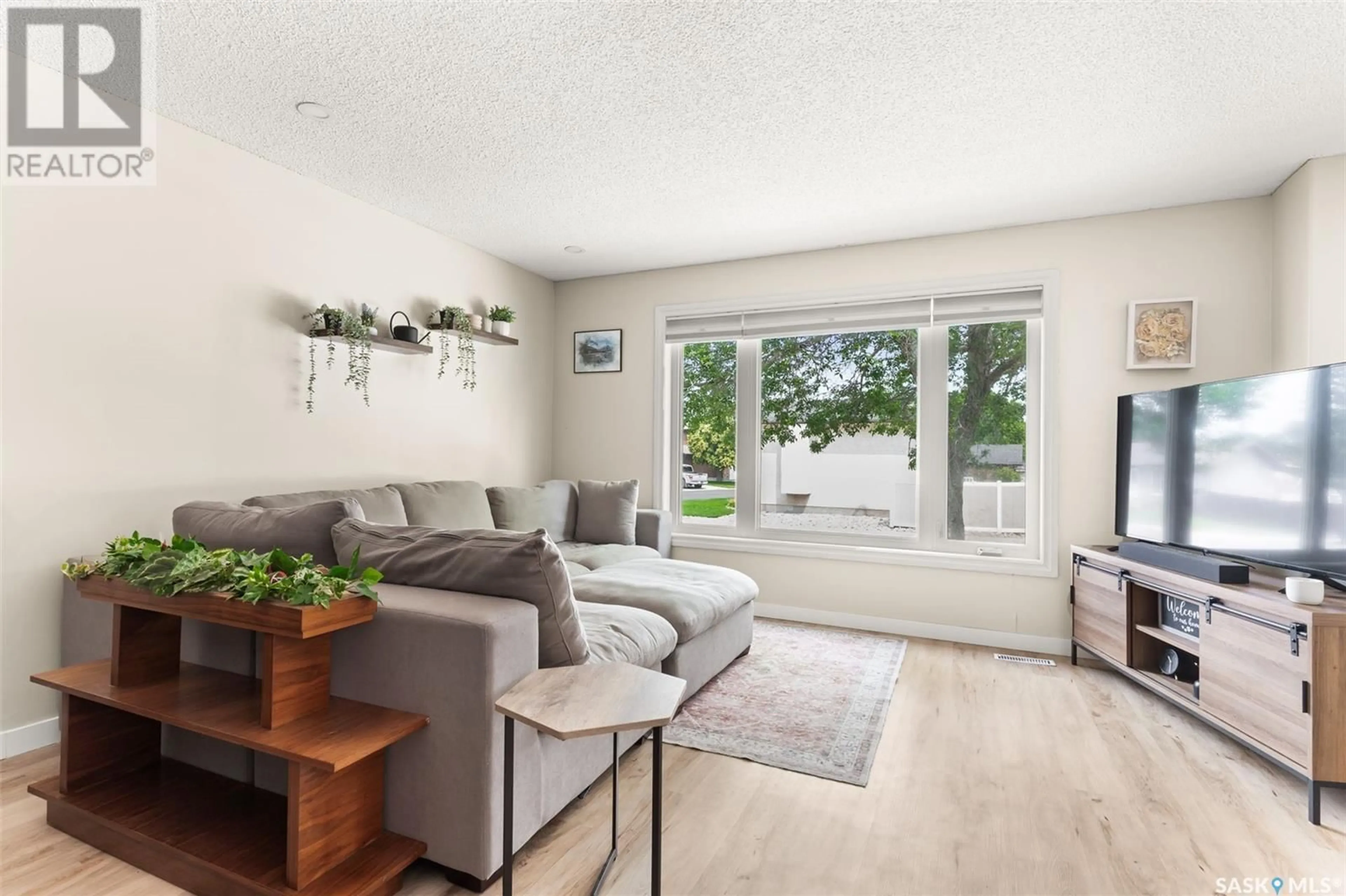 Living room with furniture, wood/laminate floor for 1210 ARNASON STREET, Regina Saskatchewan S4X3W3