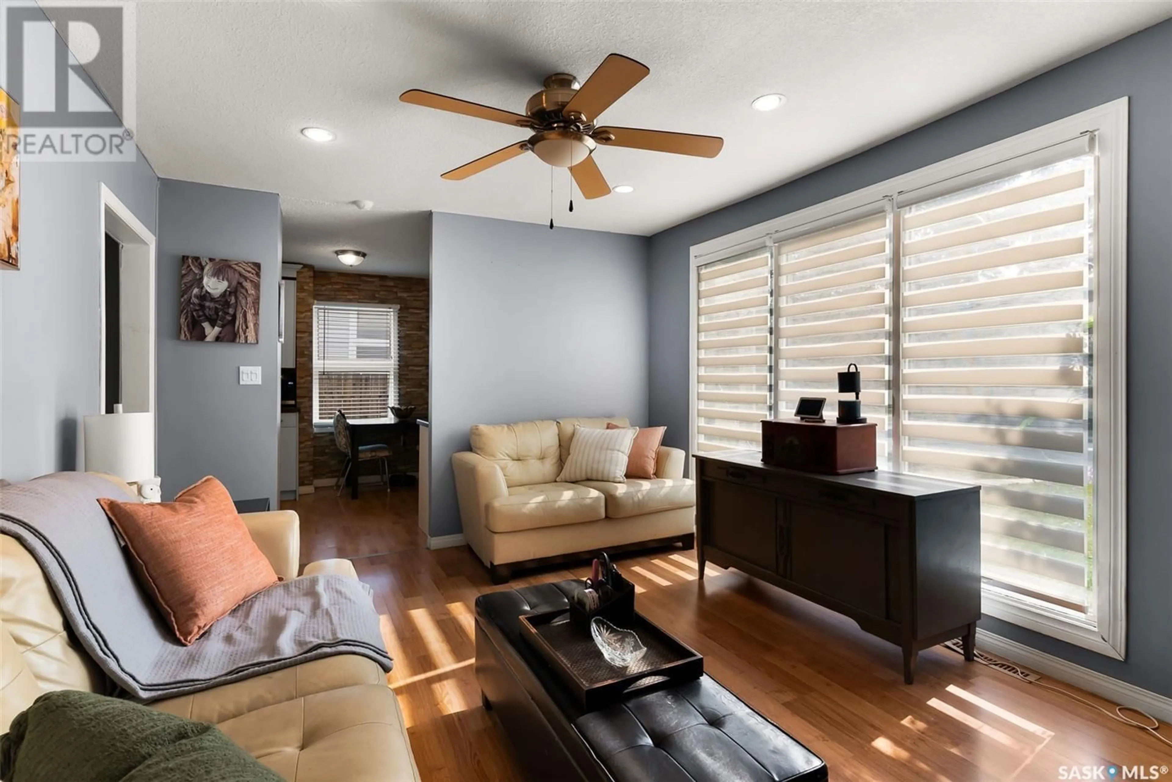 Living room with furniture, wood/laminate floor for 32 MERRITT CRESCENT, Regina Saskatchewan S4T5Y2