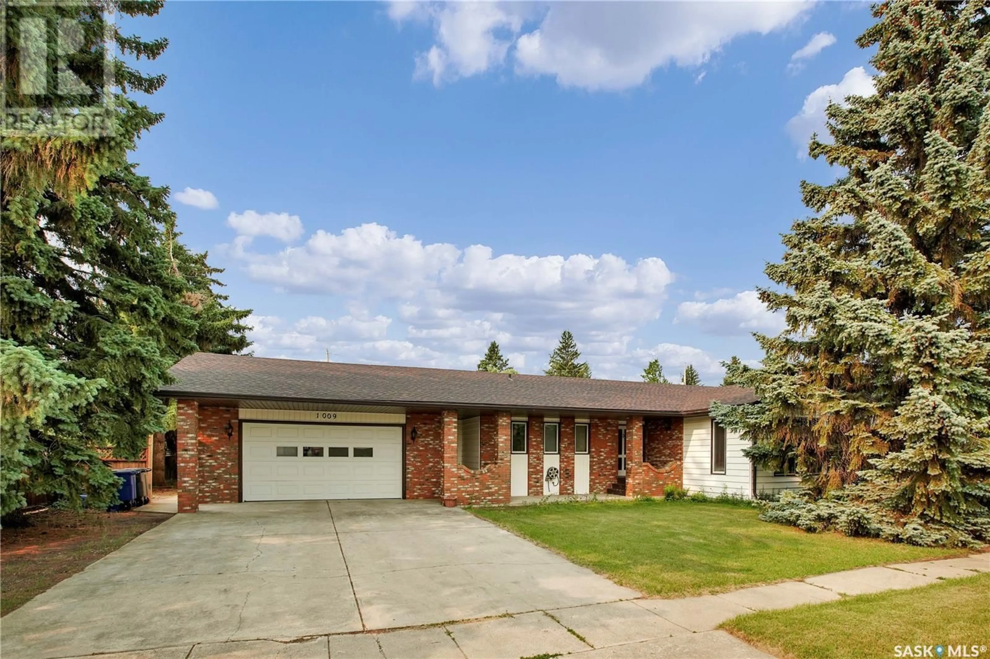 Home with brick exterior material, street for 1009 8TH STREET, Rosthern Saskatchewan S0K3R0