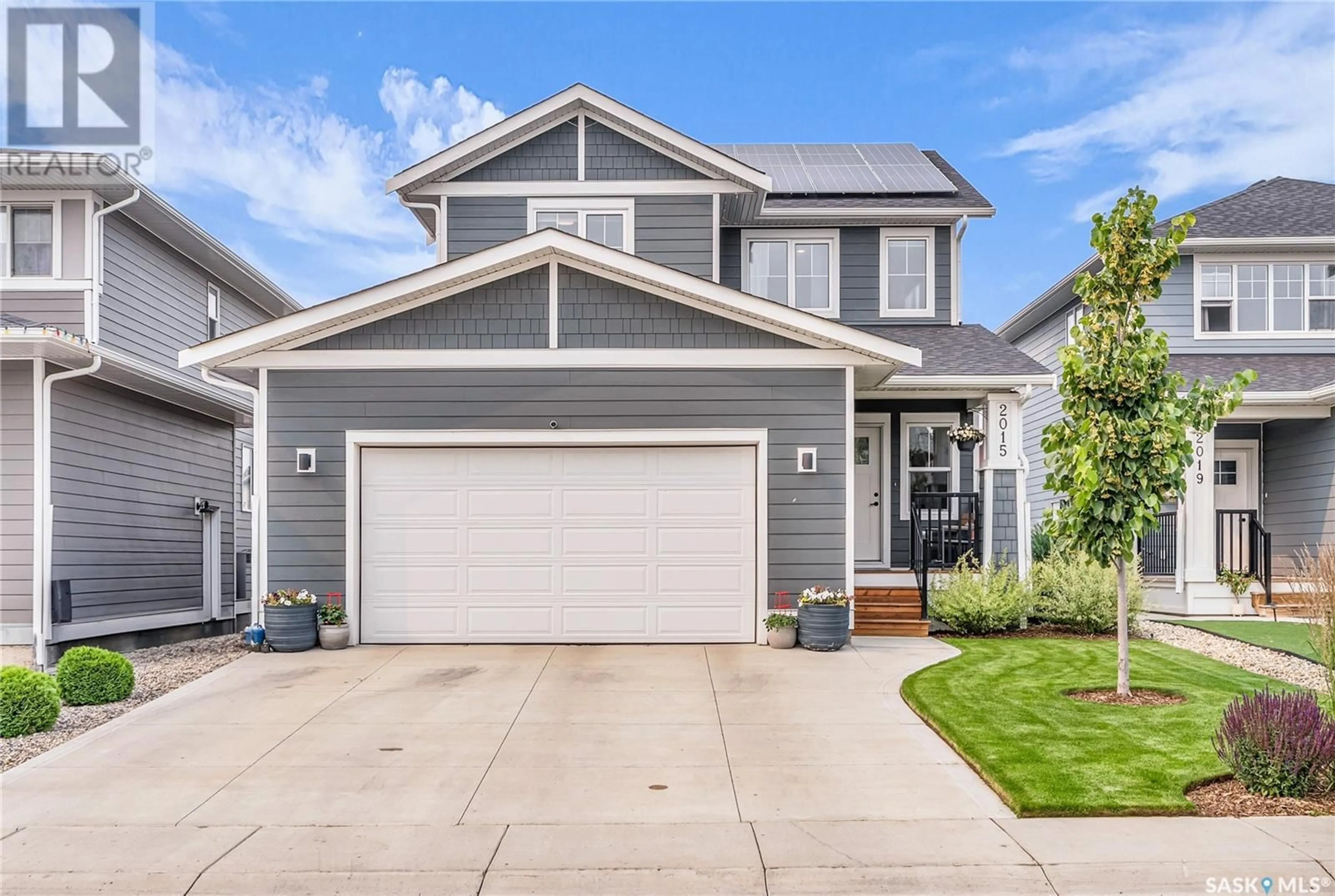 Home with vinyl exterior material, street for 2015 STILLING LANE, Saskatoon Saskatchewan S7V0X2