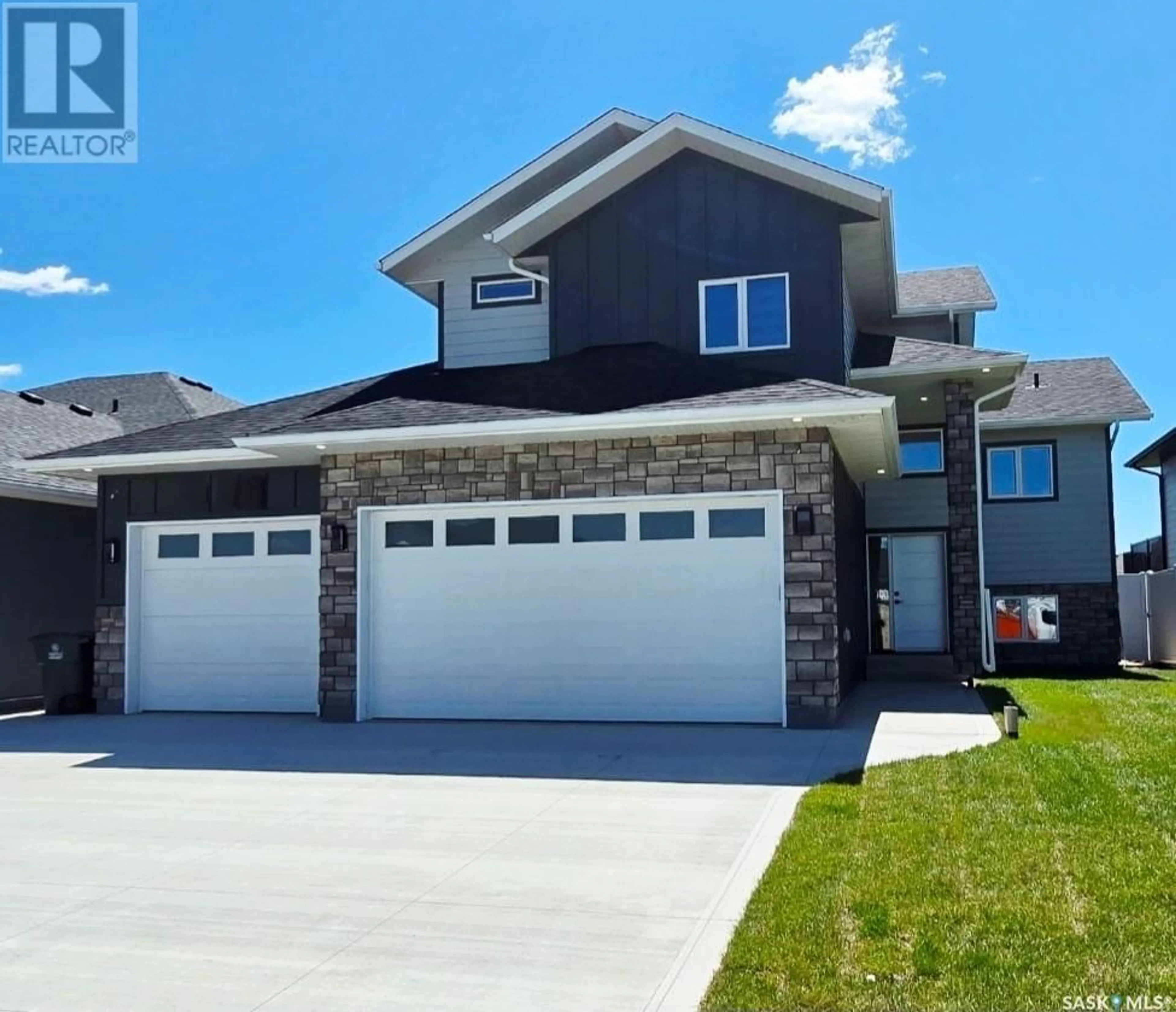 Home with vinyl exterior material, street for 703 BALLESTEROS CRESCENT, Warman Saskatchewan S0K4S4