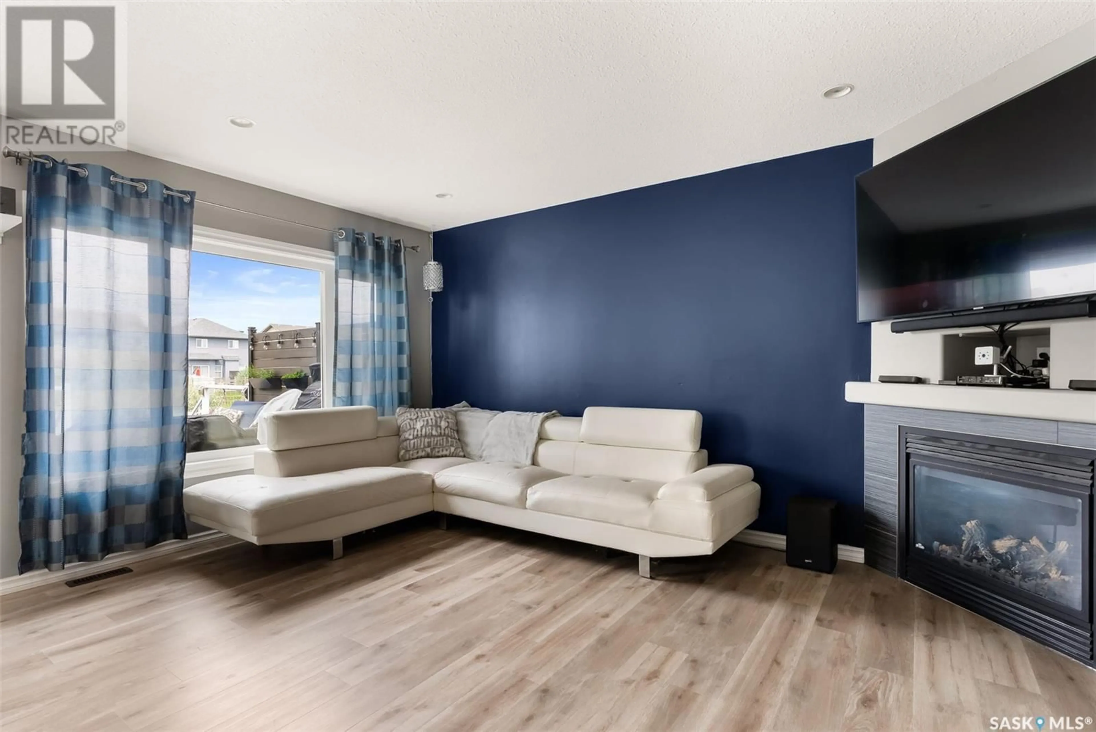 Living room with furniture, wood/laminate floor for 5416 AERIAL CRESCENT, Regina Saskatchewan S4W0C9
