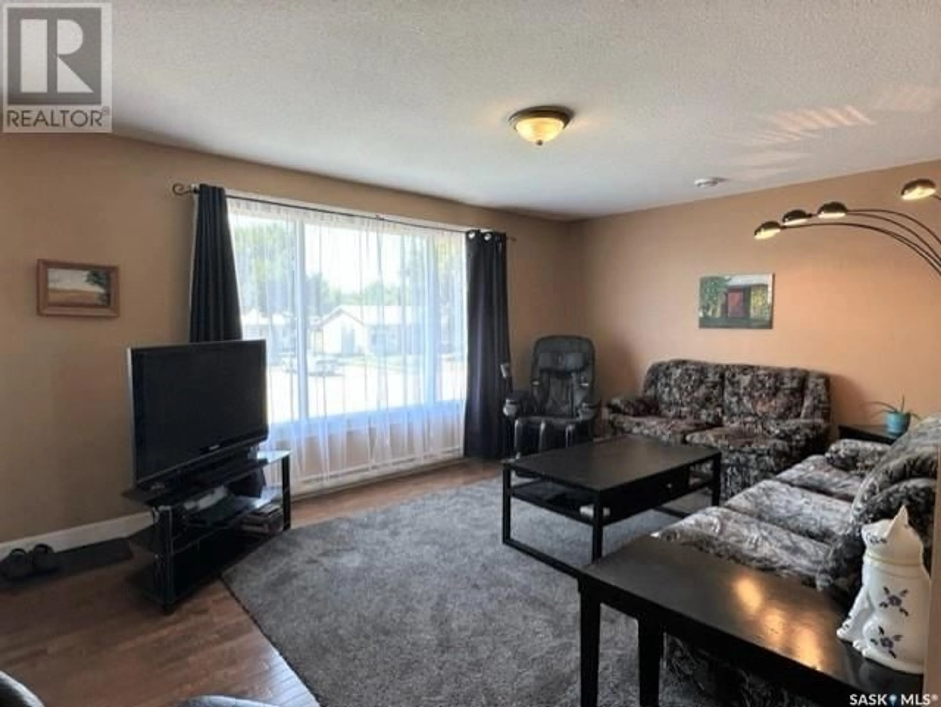 Living room with furniture, wood/laminate floor for 112 MANITOBA STREET, Melville Saskatchewan S0A2P0