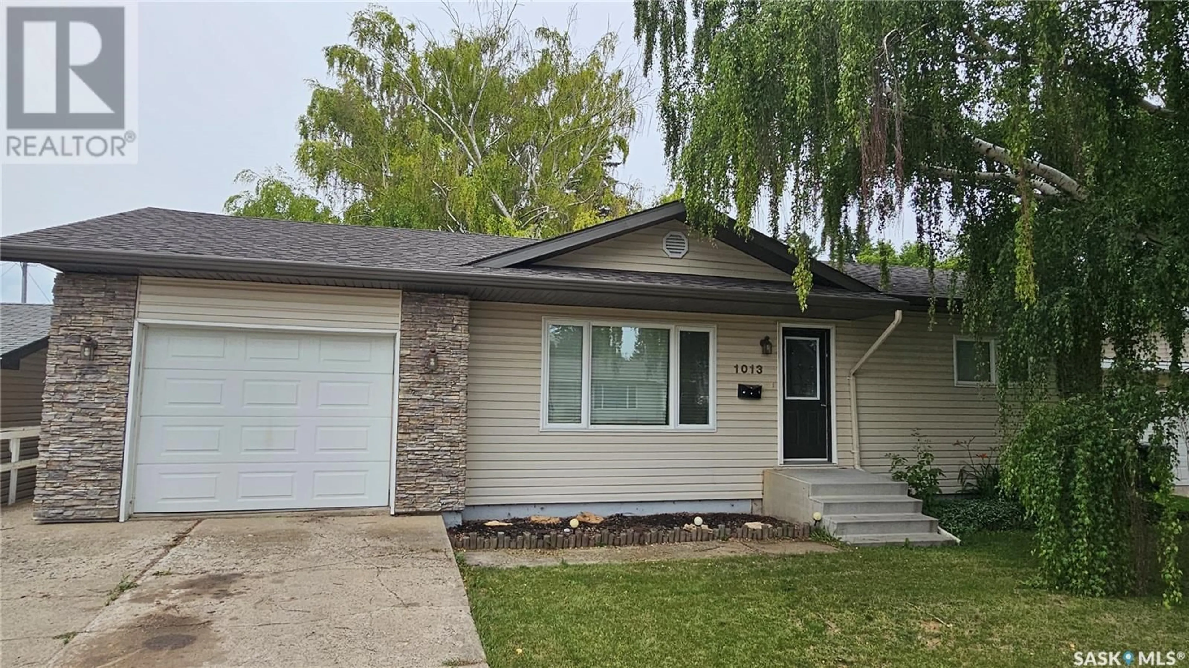 Home with vinyl exterior material, street for 1013 12TH STREET, Humboldt Saskatchewan S0K2A0
